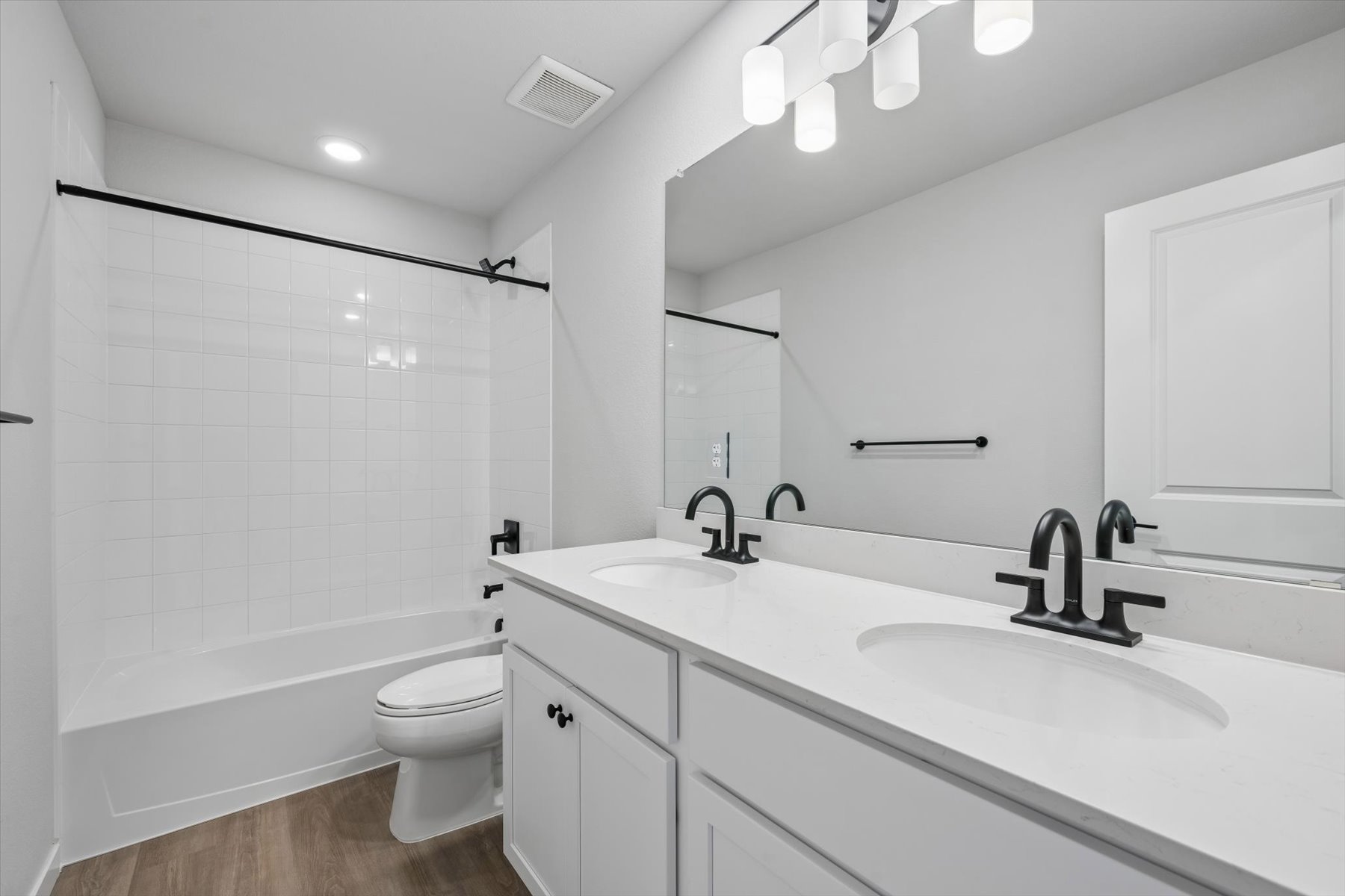 A bathroom with a tub sink and toilet.