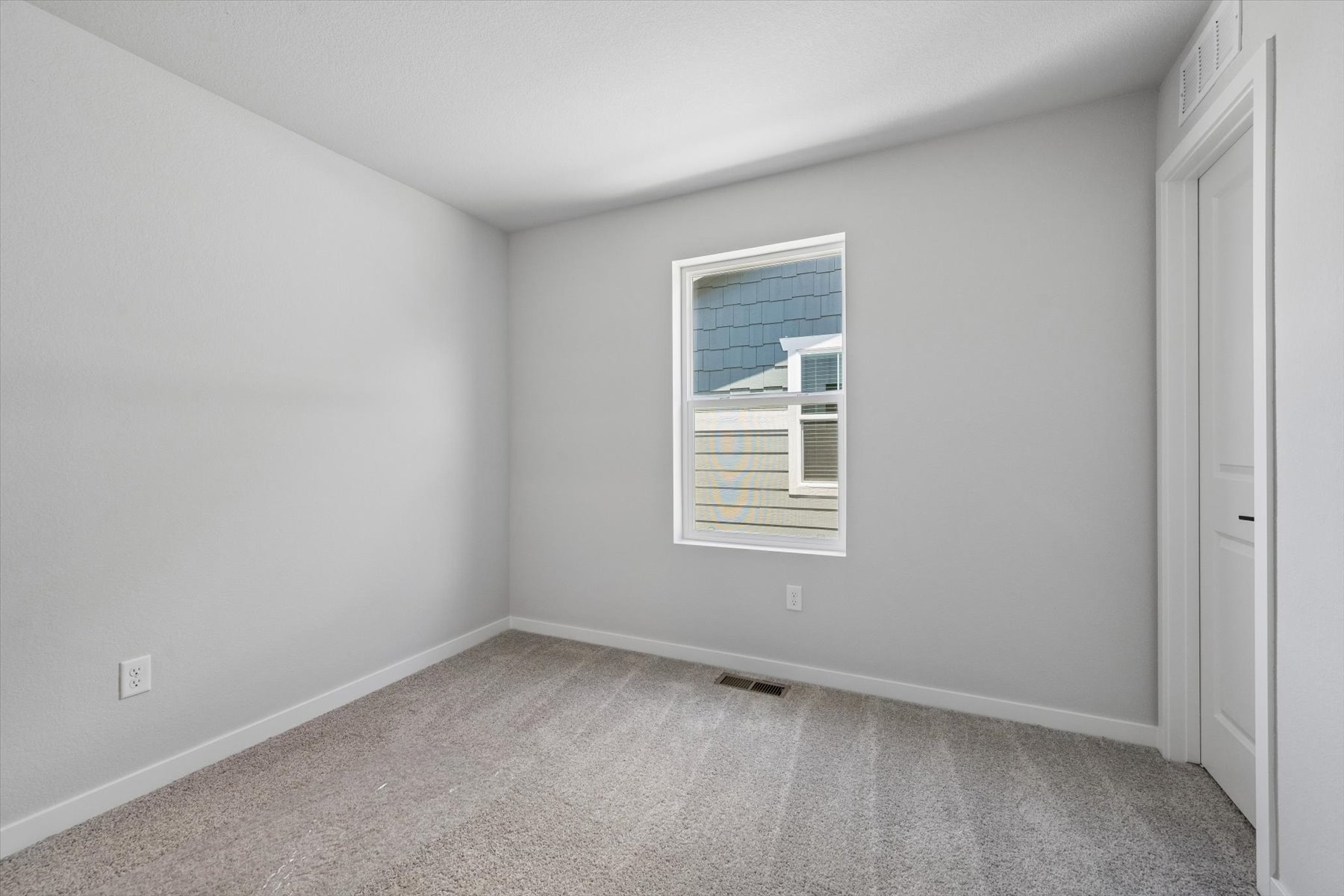A room with a window and a door.