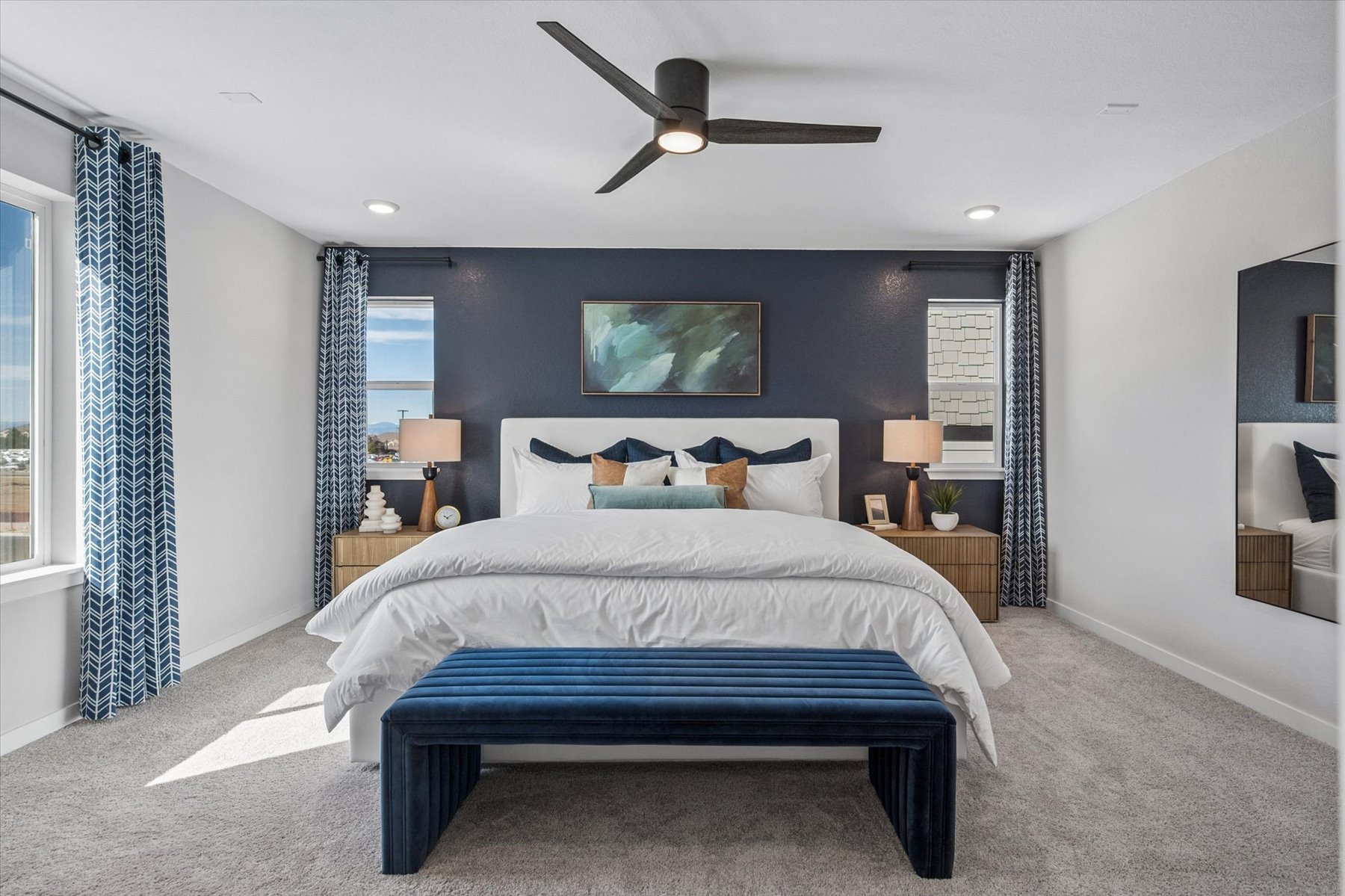 A bedroom with a bed and a bench.