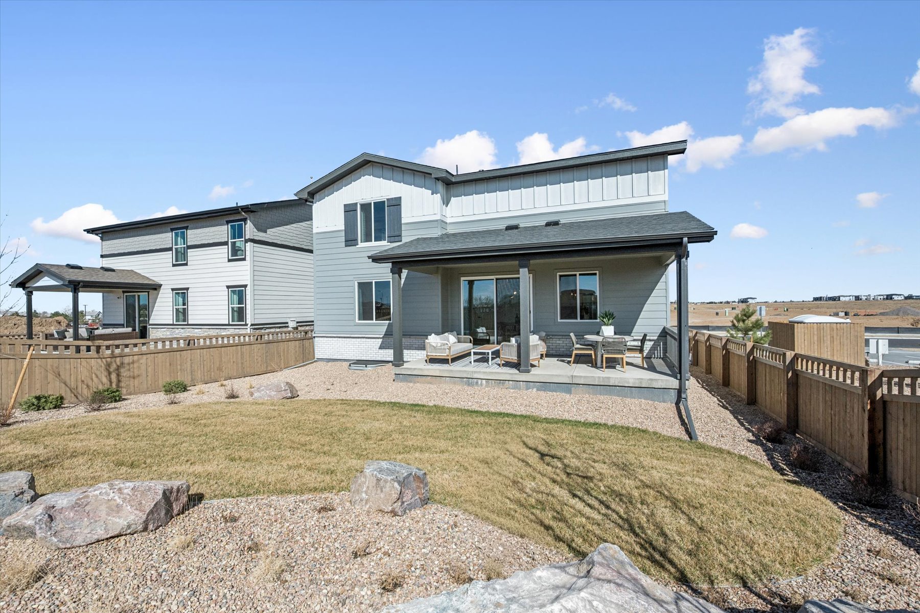 A house with a fence and a yard with a dirt yard.