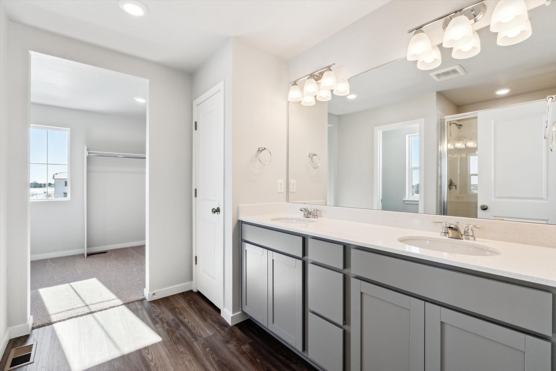A bathroom with a large mirror.
