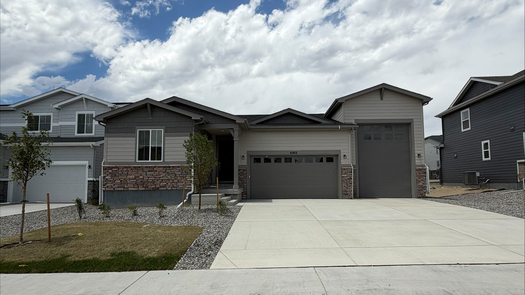 A house with garages and a driveway.