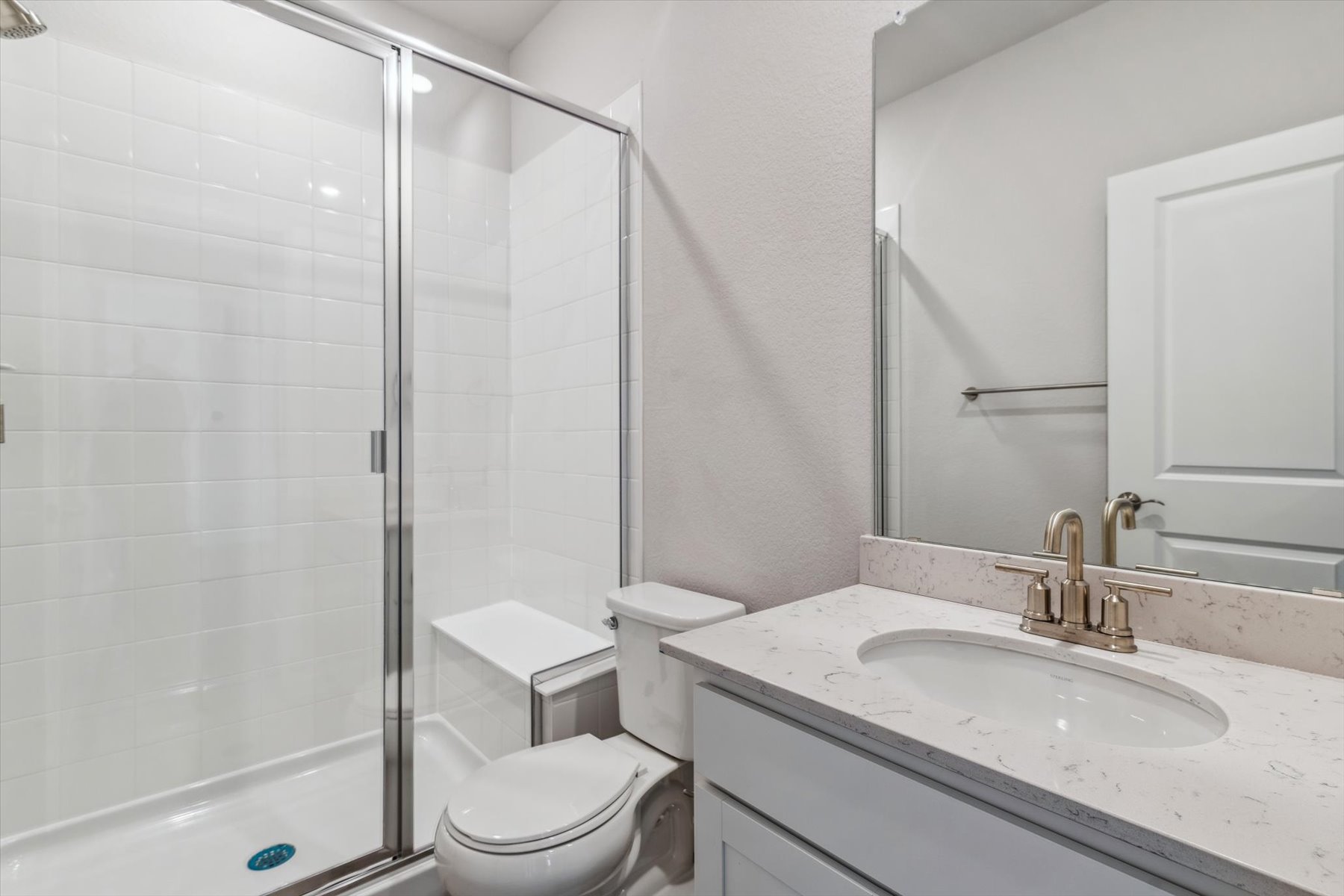A bathroom with a glass shower.