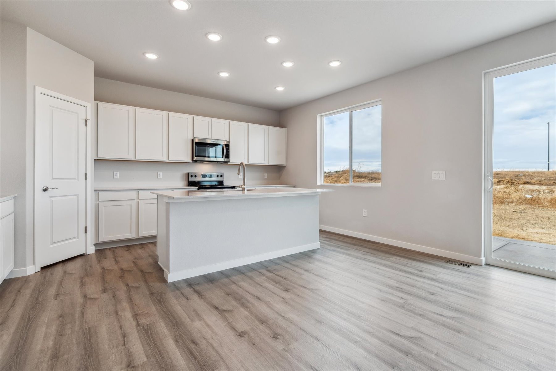A kitchen with white cabinets.
