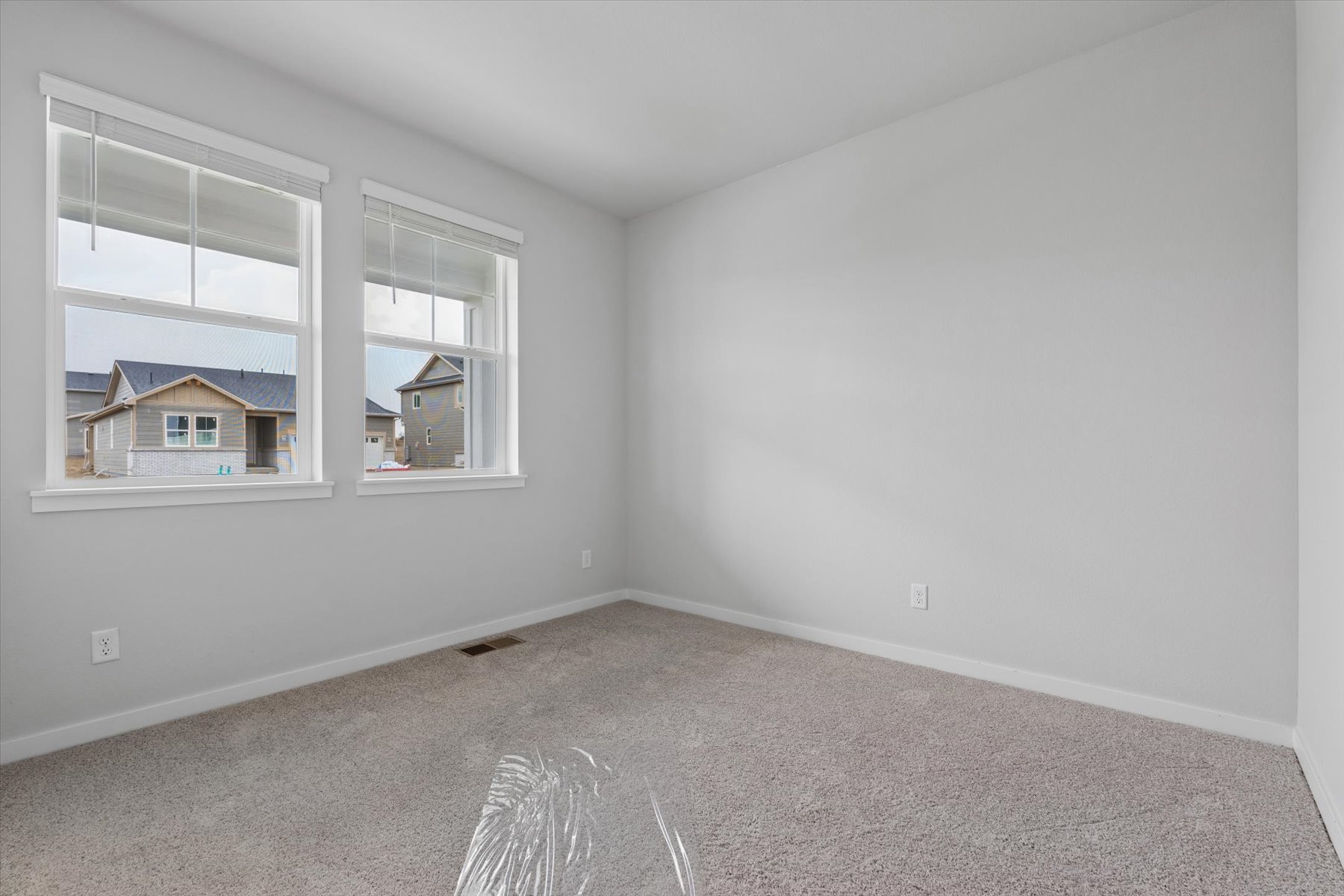 A room with a window and a carpet.