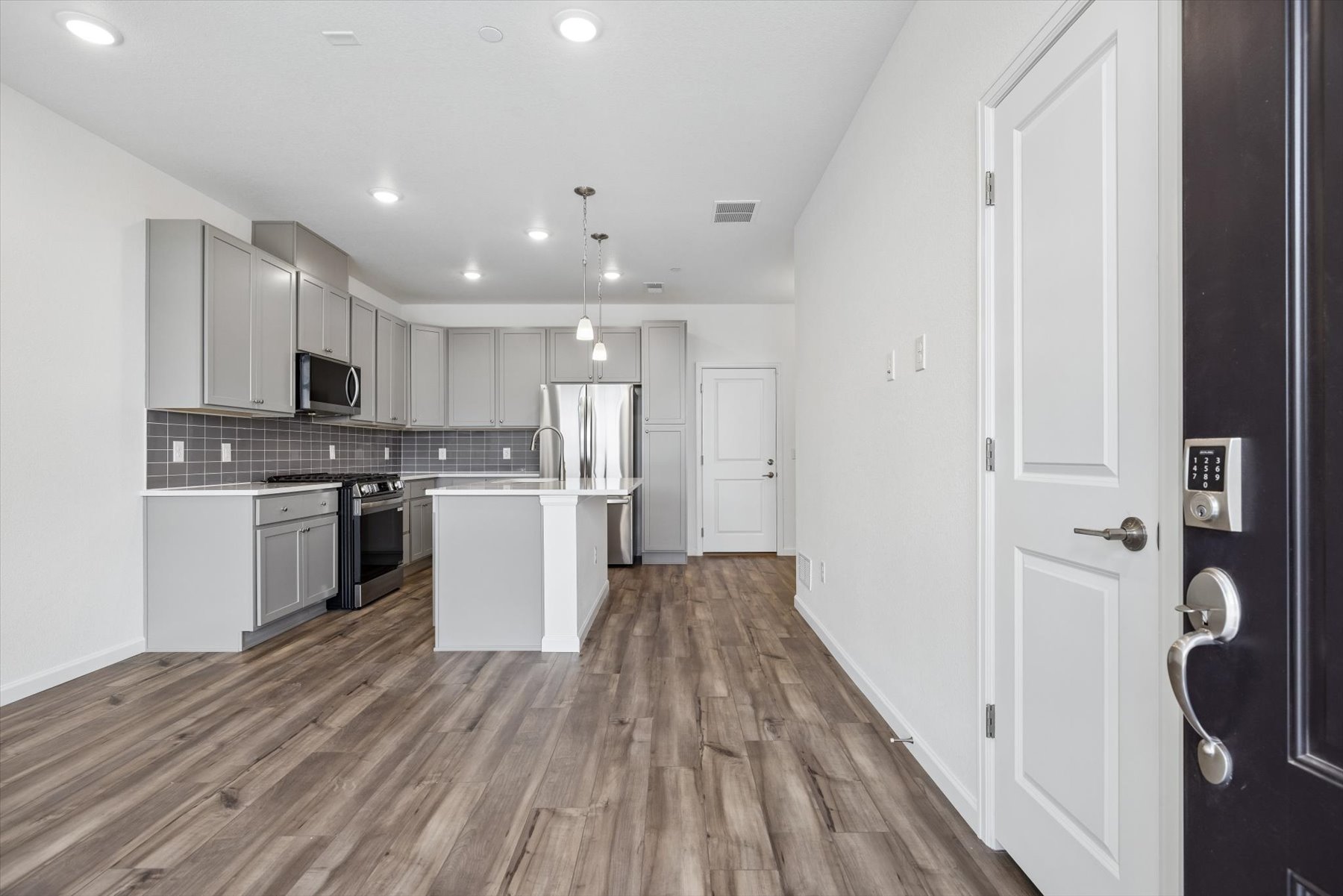 A kitchen with white cabinets.