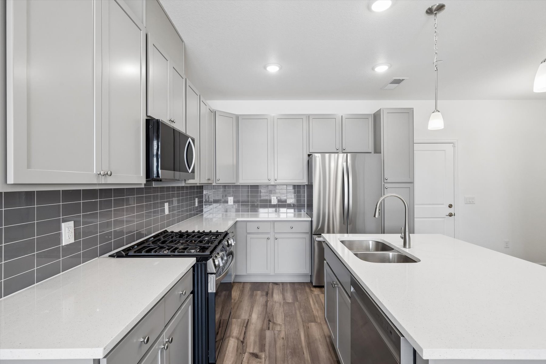 A kitchen with white cabinets.
