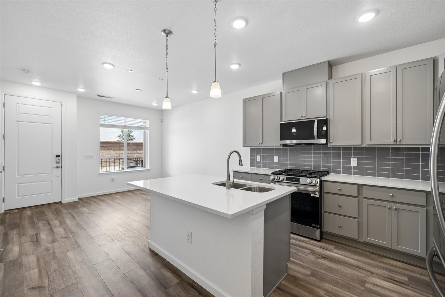 A kitchen with white cabinets.