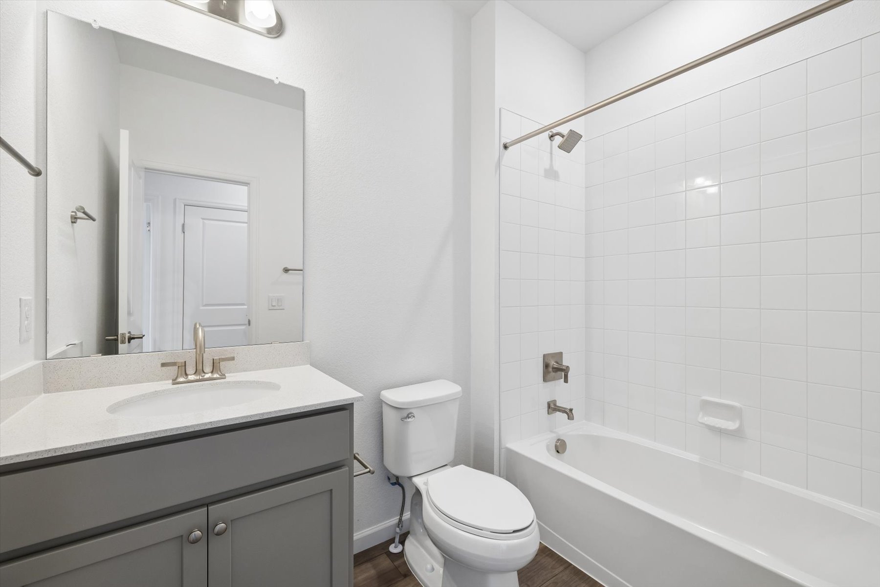 A bathroom with a tub toilet and sink.
