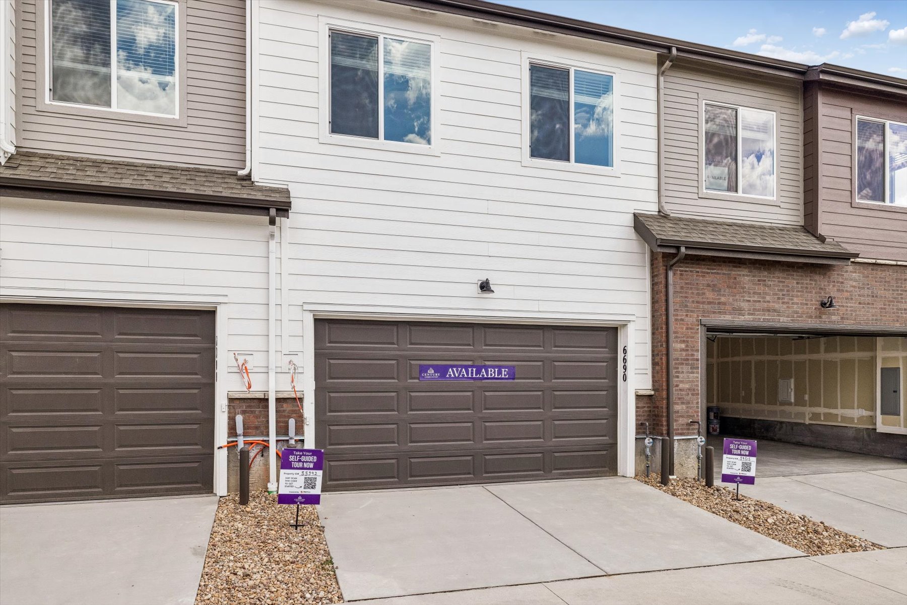 A building with garages and a sign in front of it.