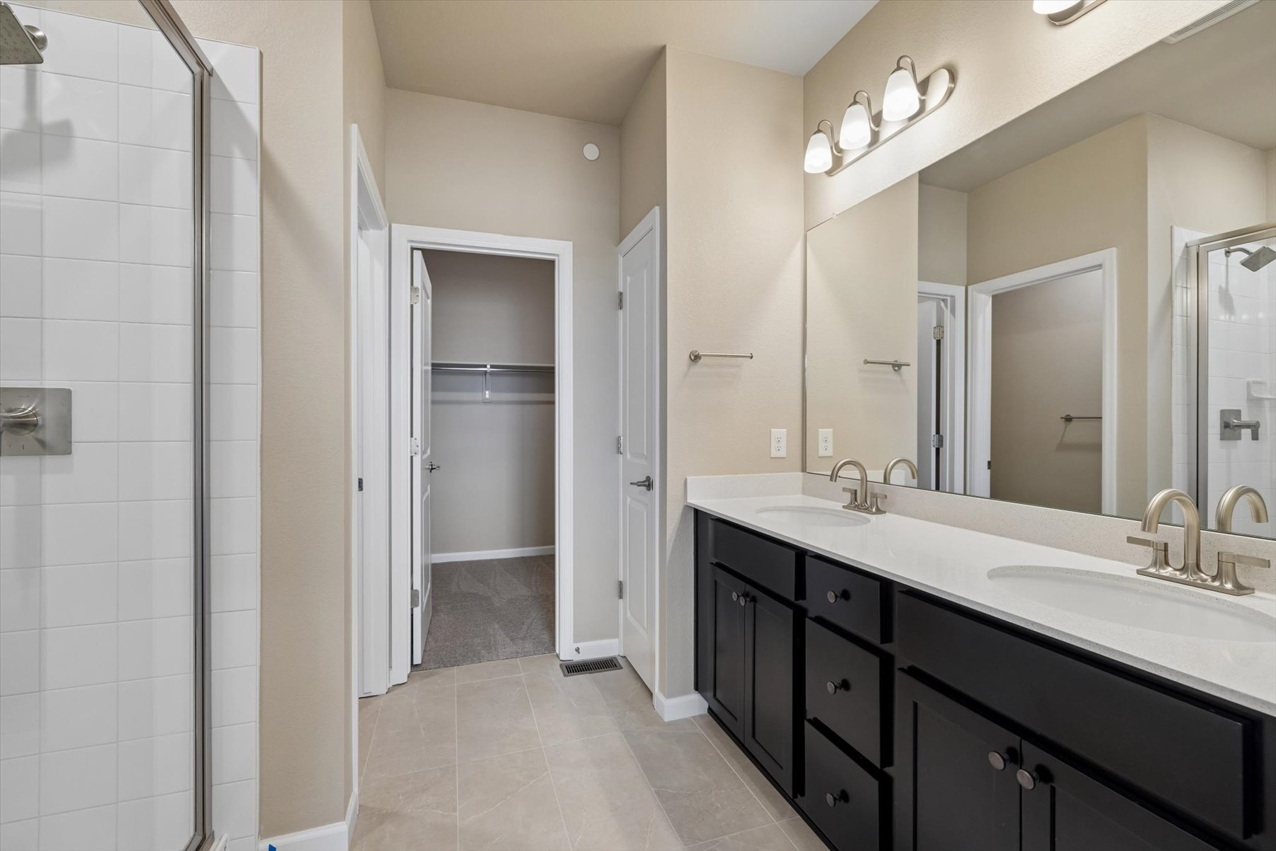 A bathroom with a shower and sink.