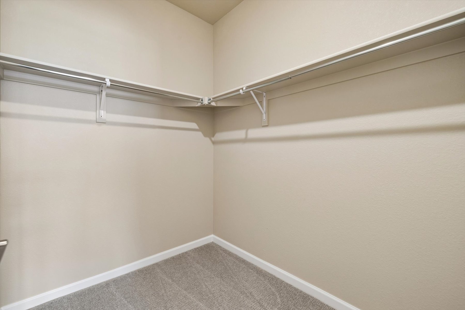 A white wall with a metal railing.