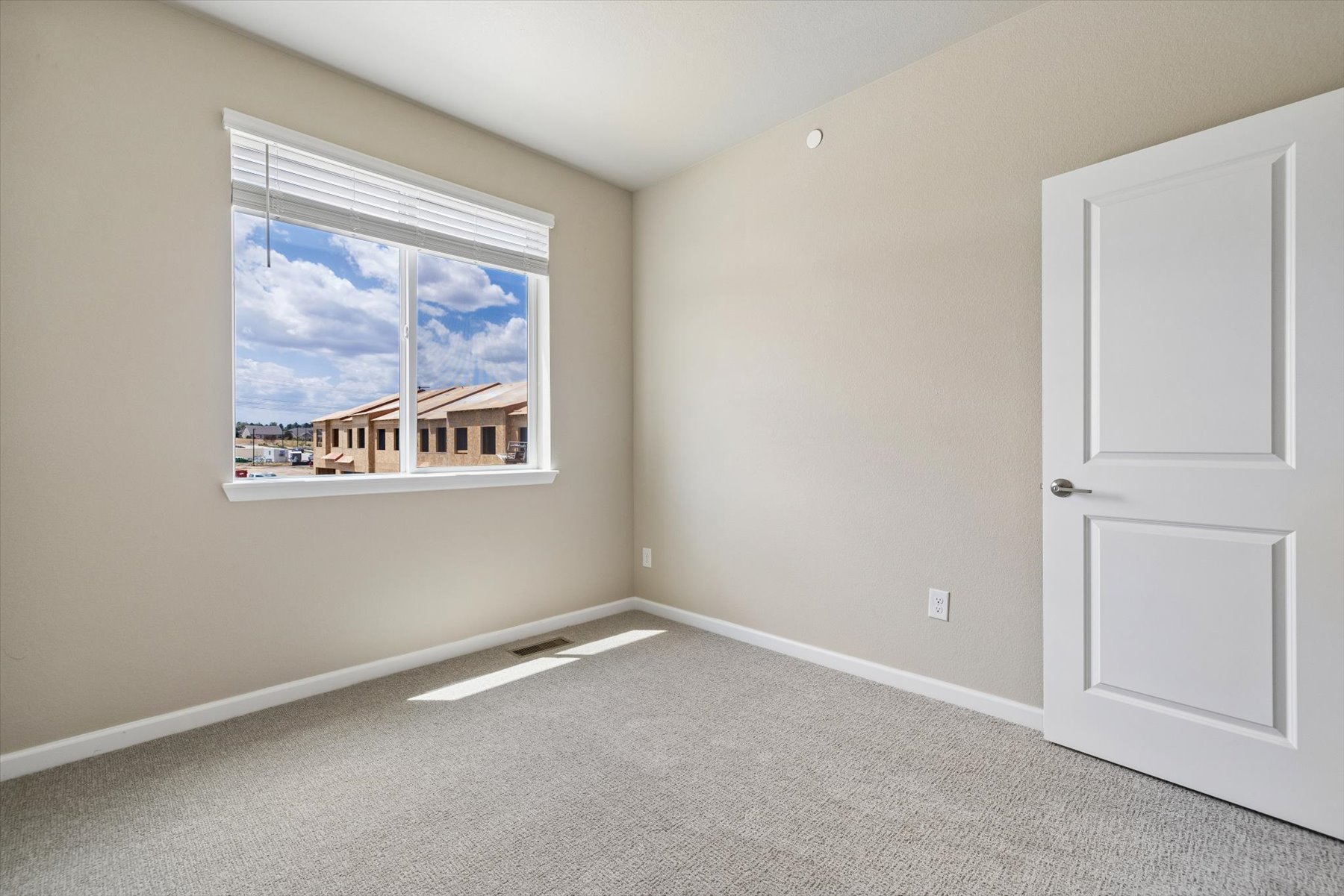 A room with a window and a door.