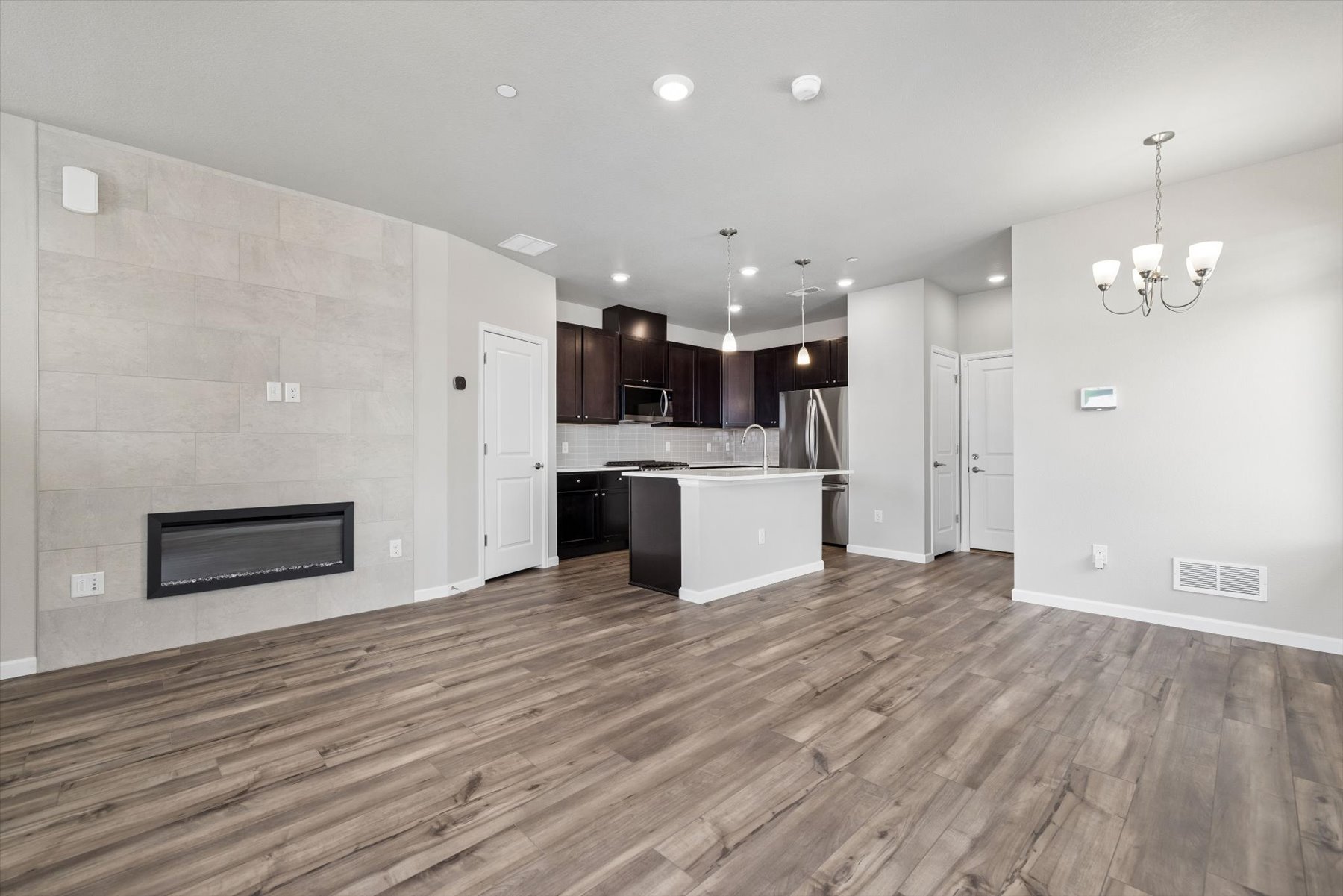 A kitchen with a wood floor.