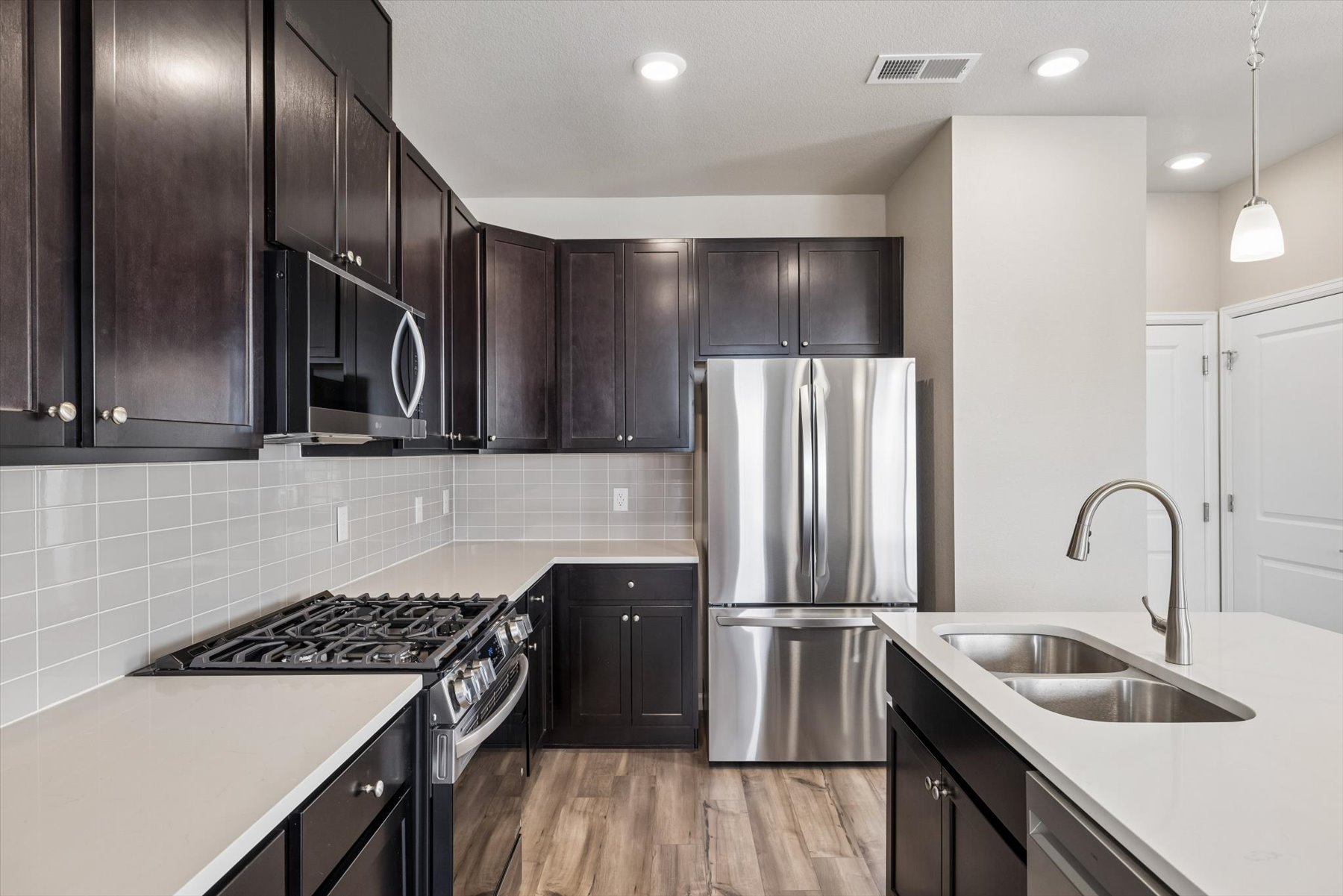 A kitchen with black cabinets.