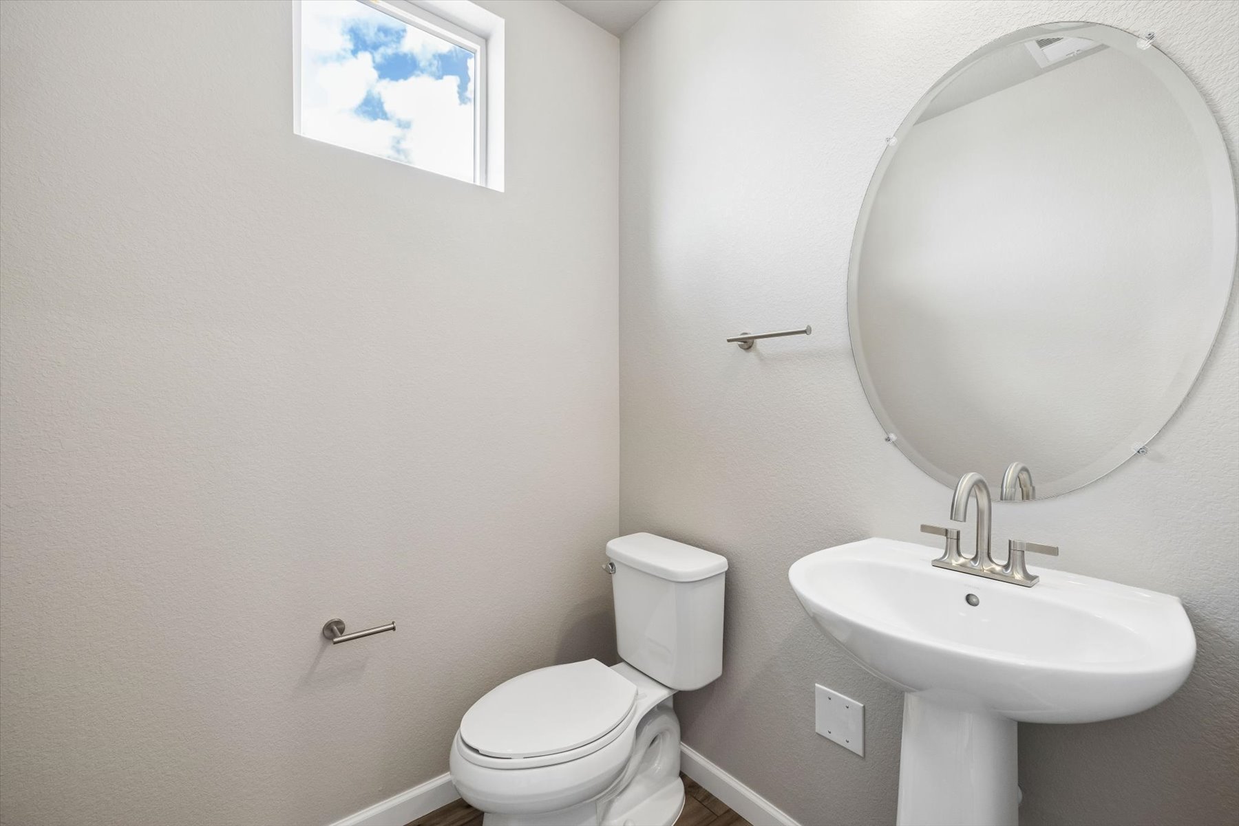 A bathroom with a toilet and sink.