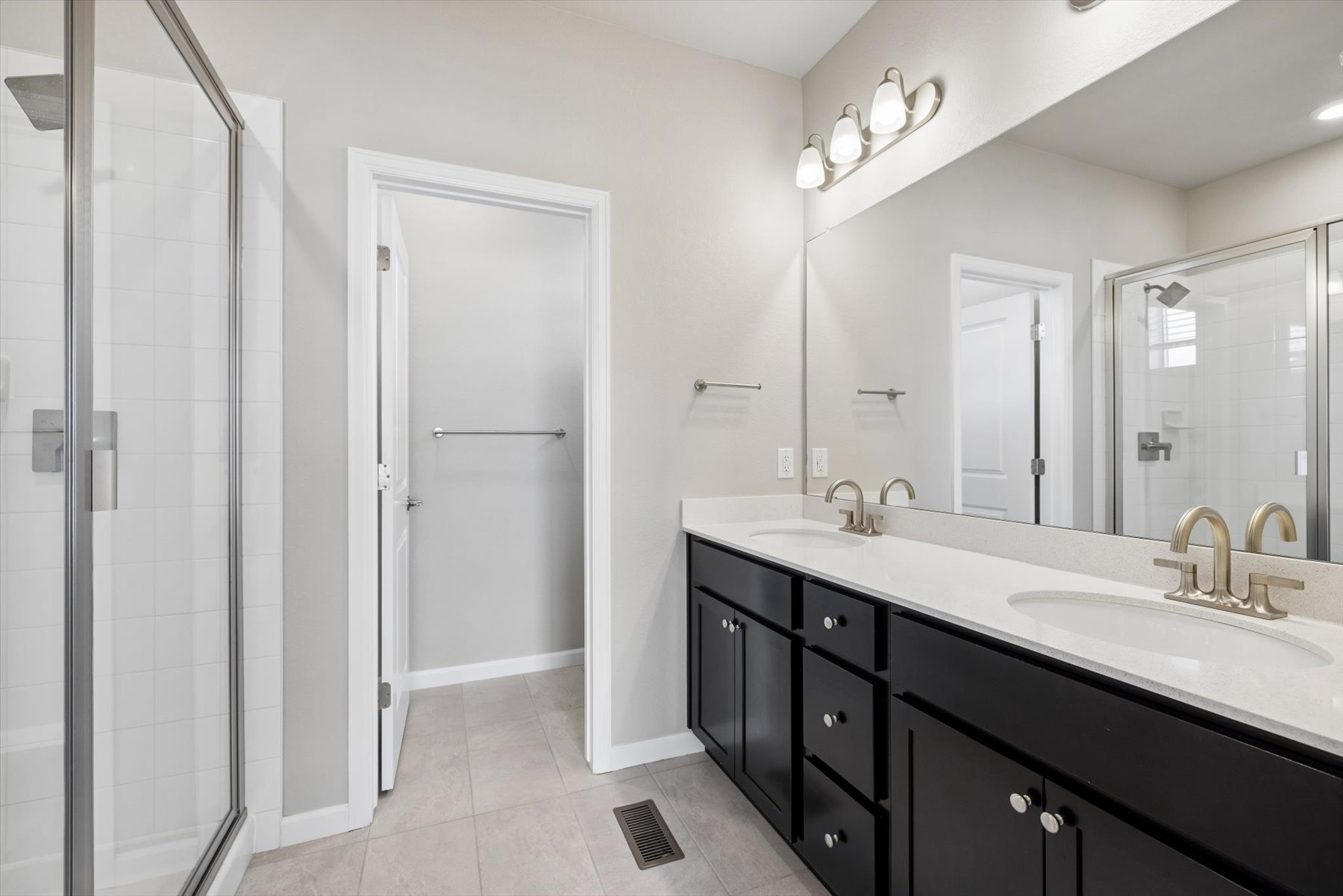 A bathroom with a sink and shower.