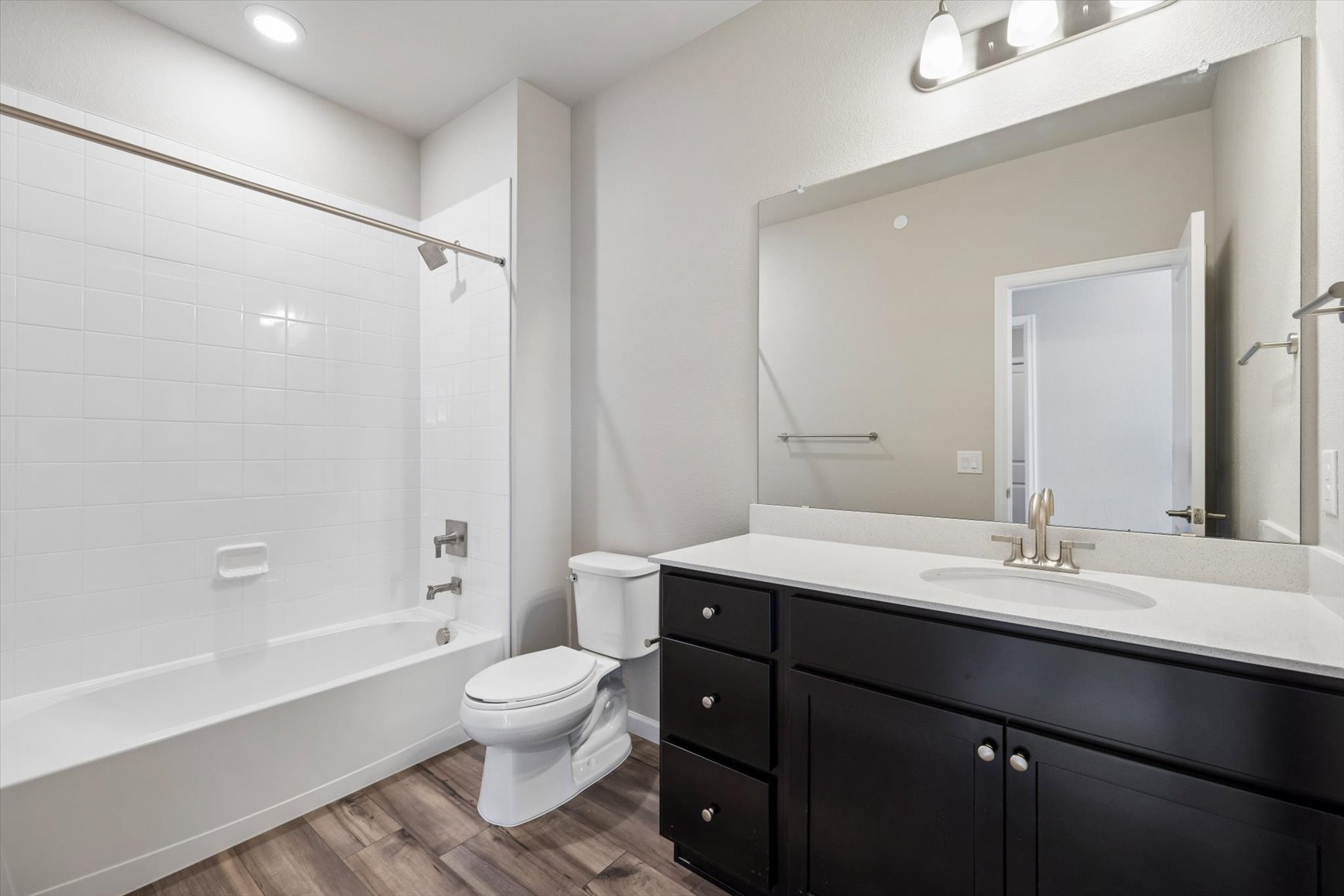 A bathroom with a tub sink and toilet.