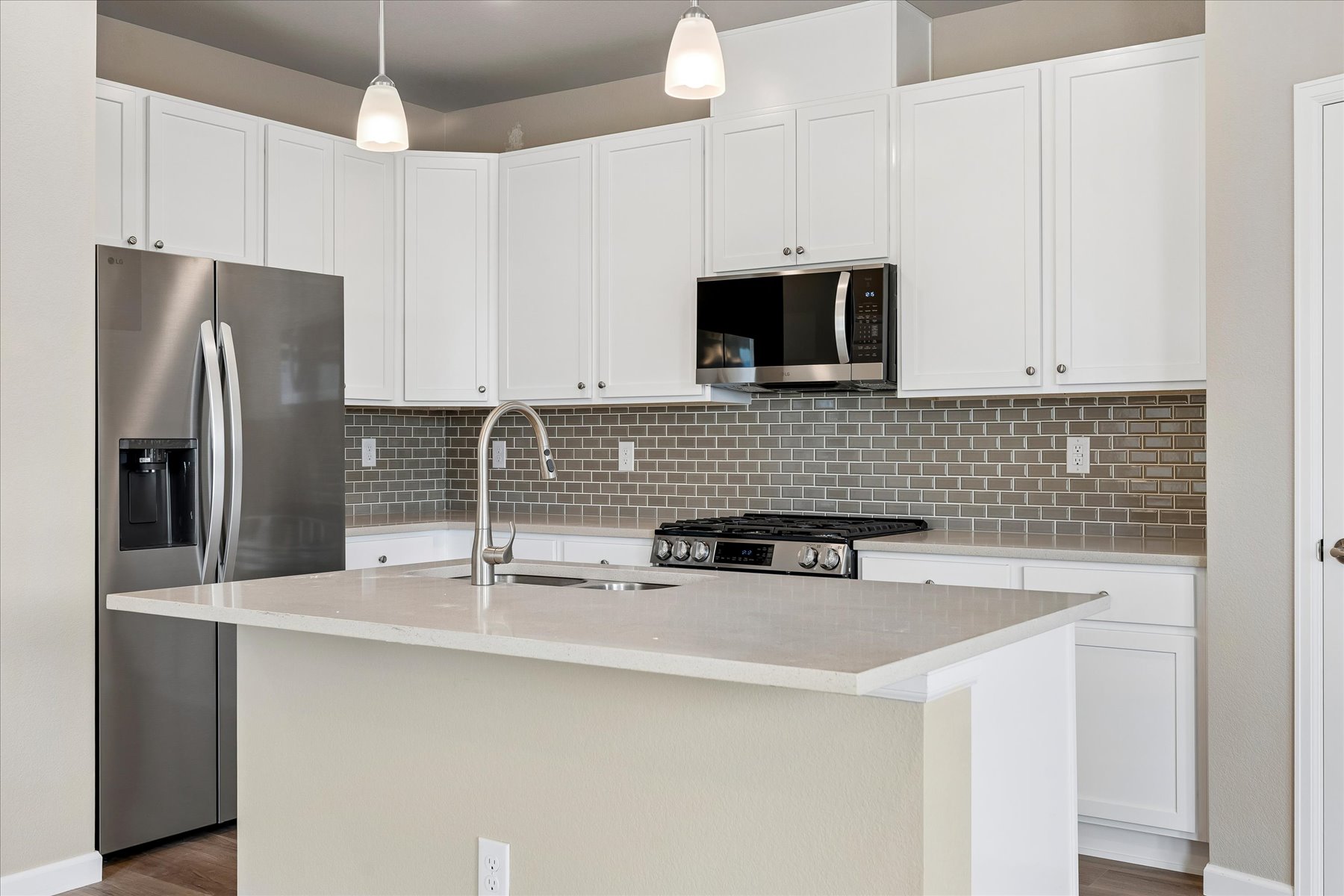 A kitchen with white cabinets.