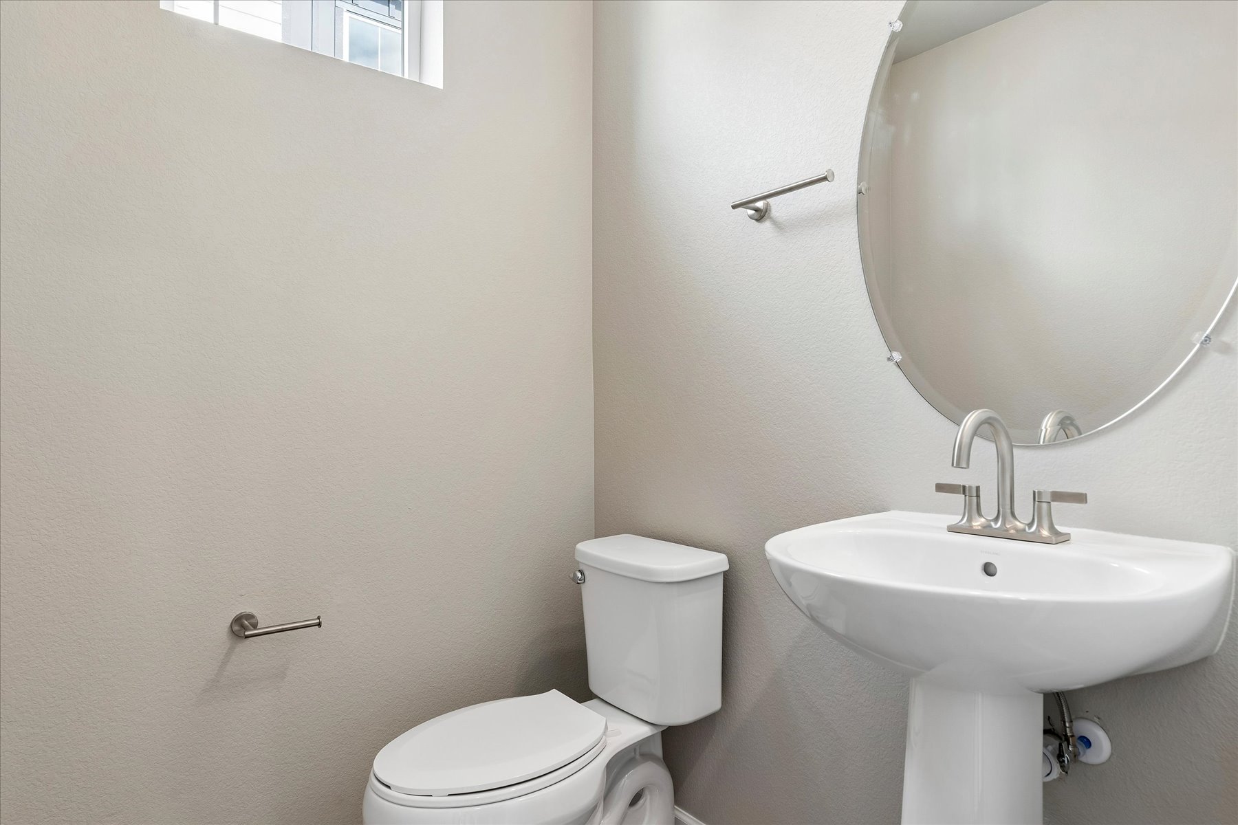 A bathroom with a toilet and sink.