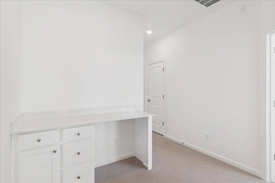 A room with white cabinets.