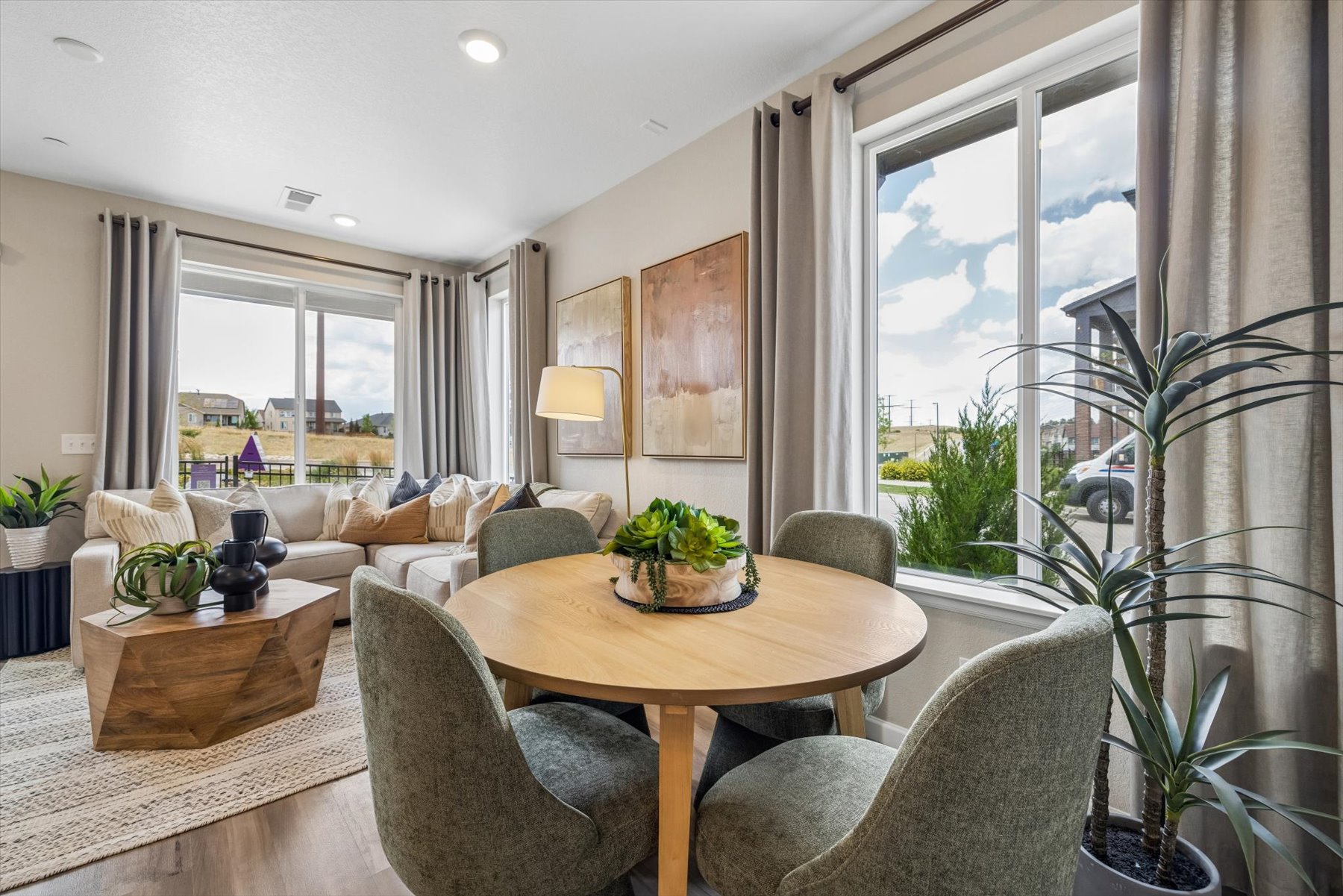 A living room with a table and chairs.