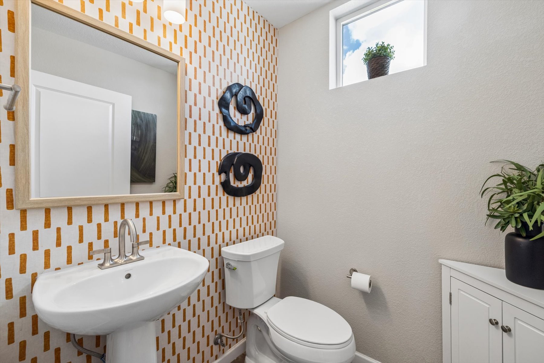 A bathroom with a toilet and sink.
