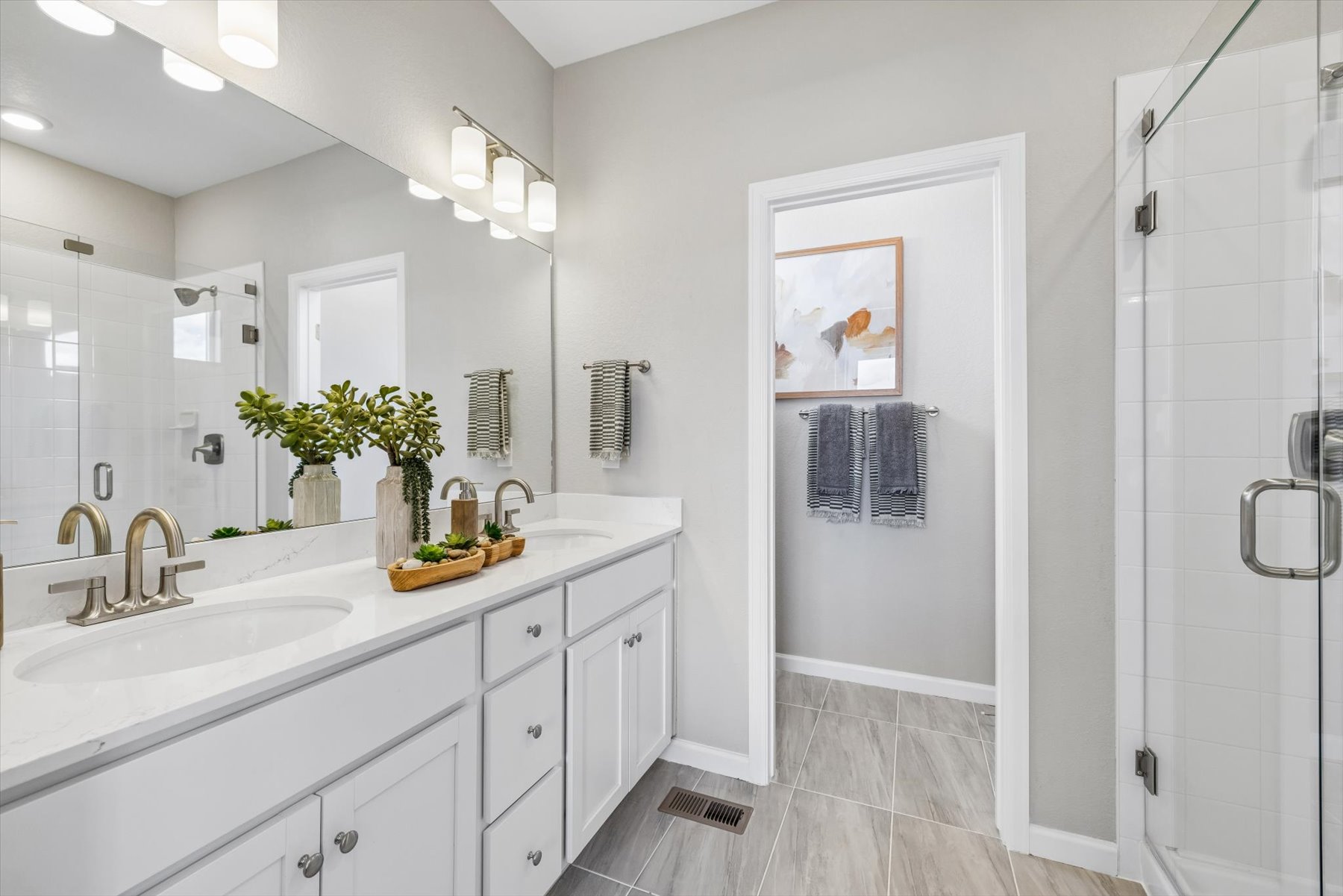 A bathroom with a sink and a shower unit.