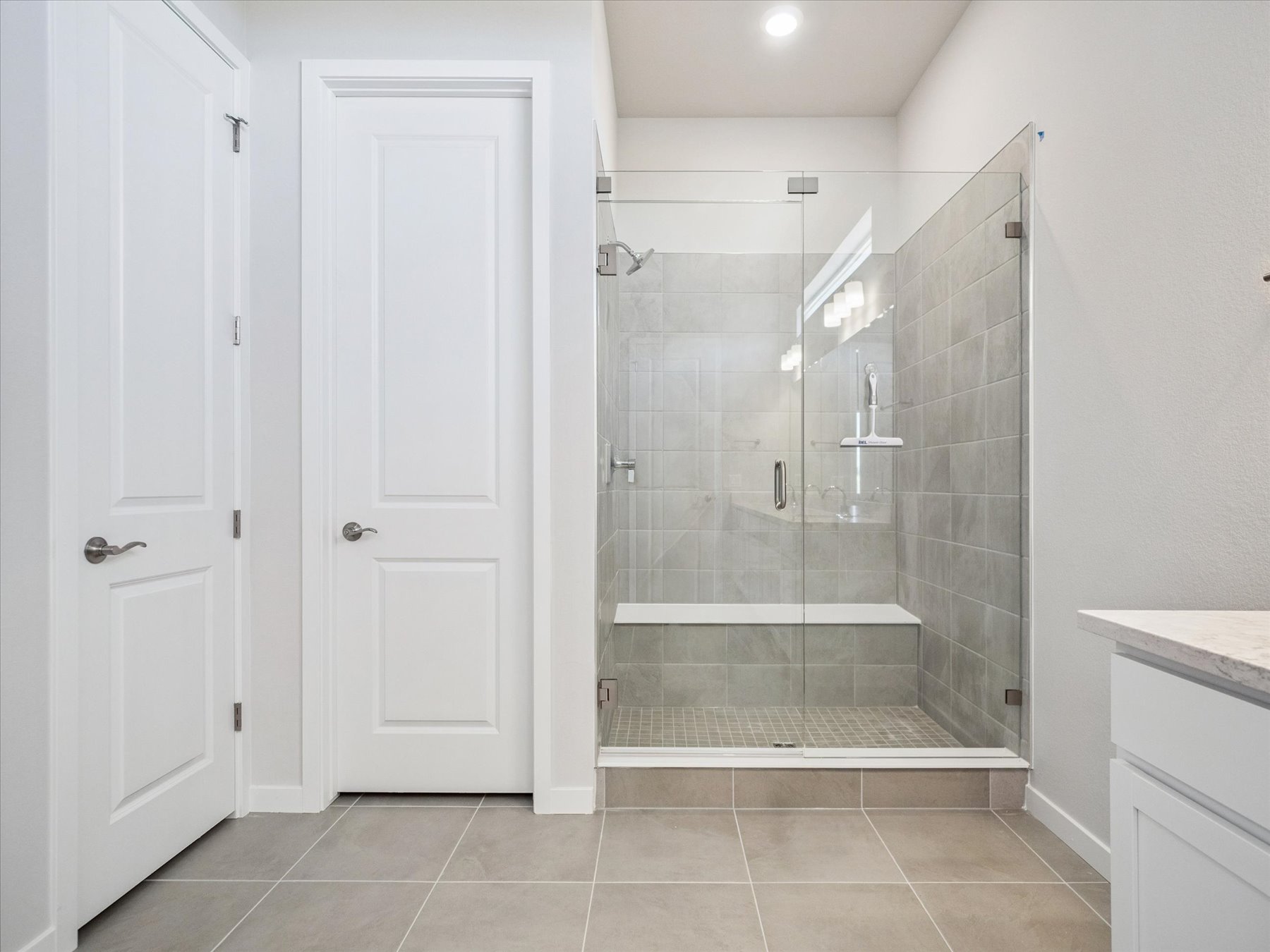 A bathroom with a glass shower.