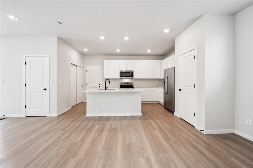 A kitchen with white cabinets.