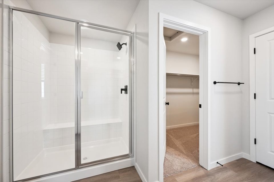 A shower with a glass door.