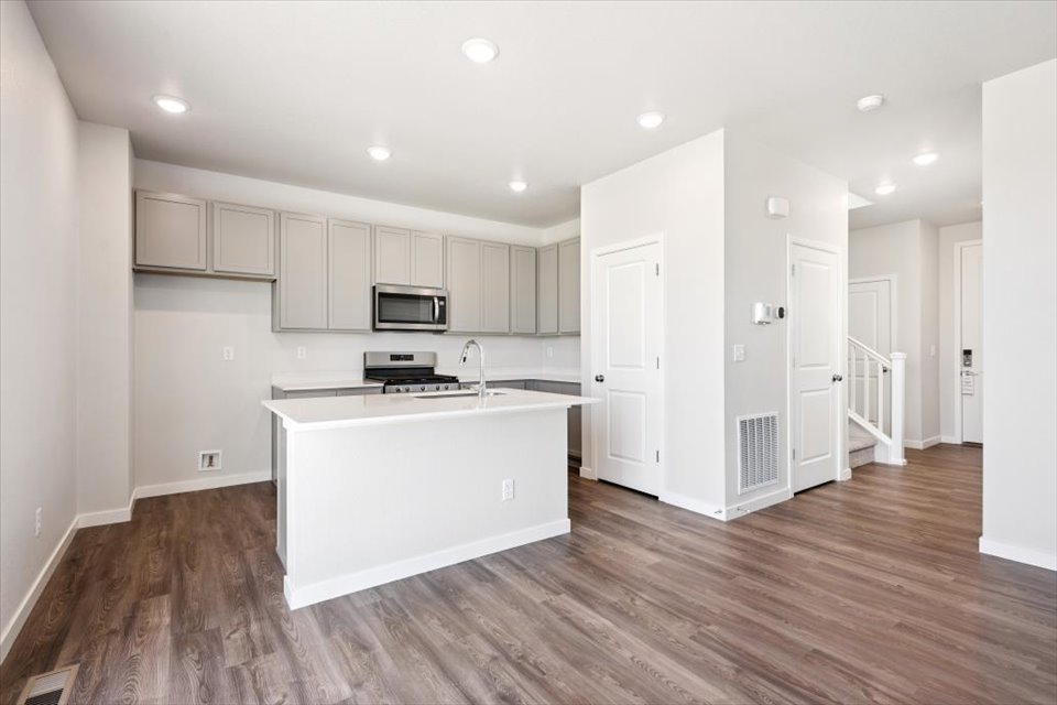A kitchen with white cabinets.