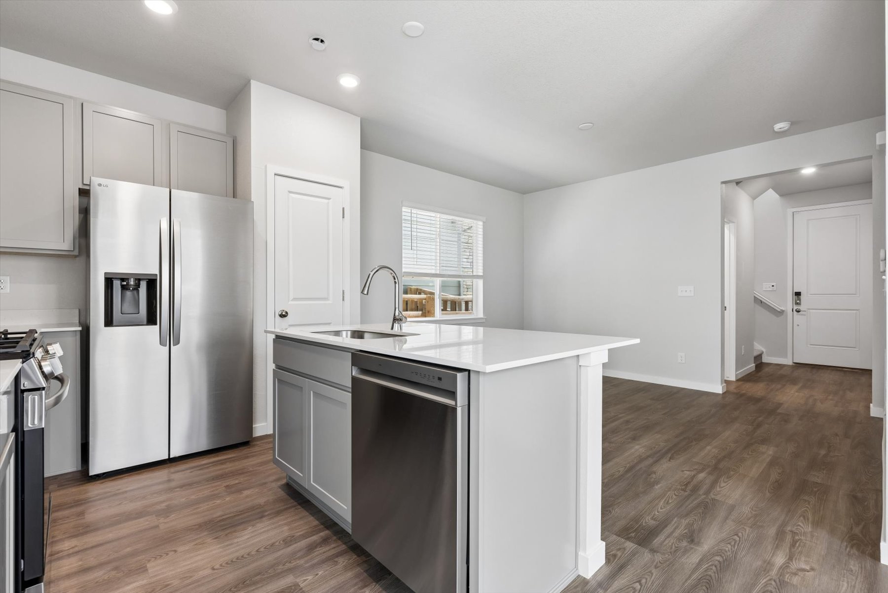 A kitchen with white cabinets.