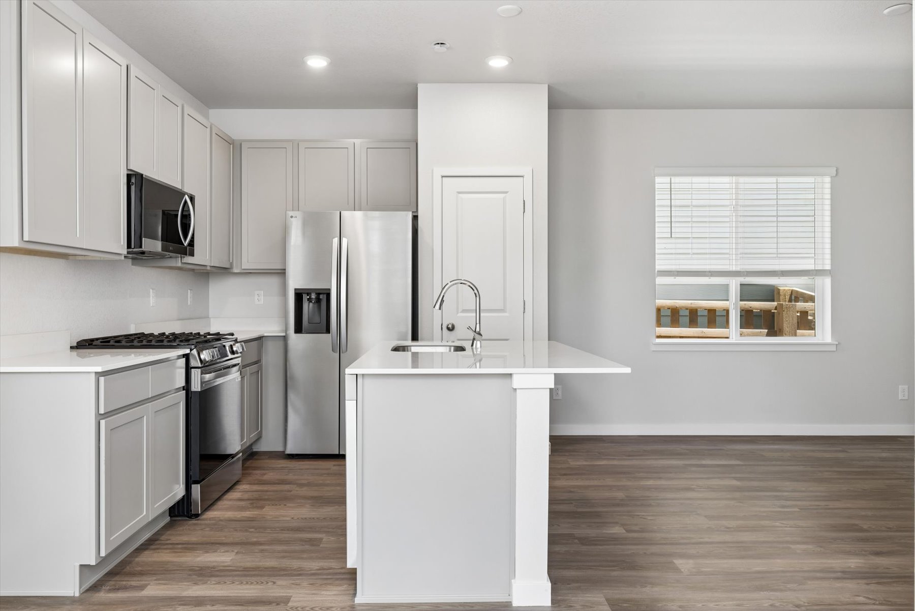 A kitchen with white cabinets.