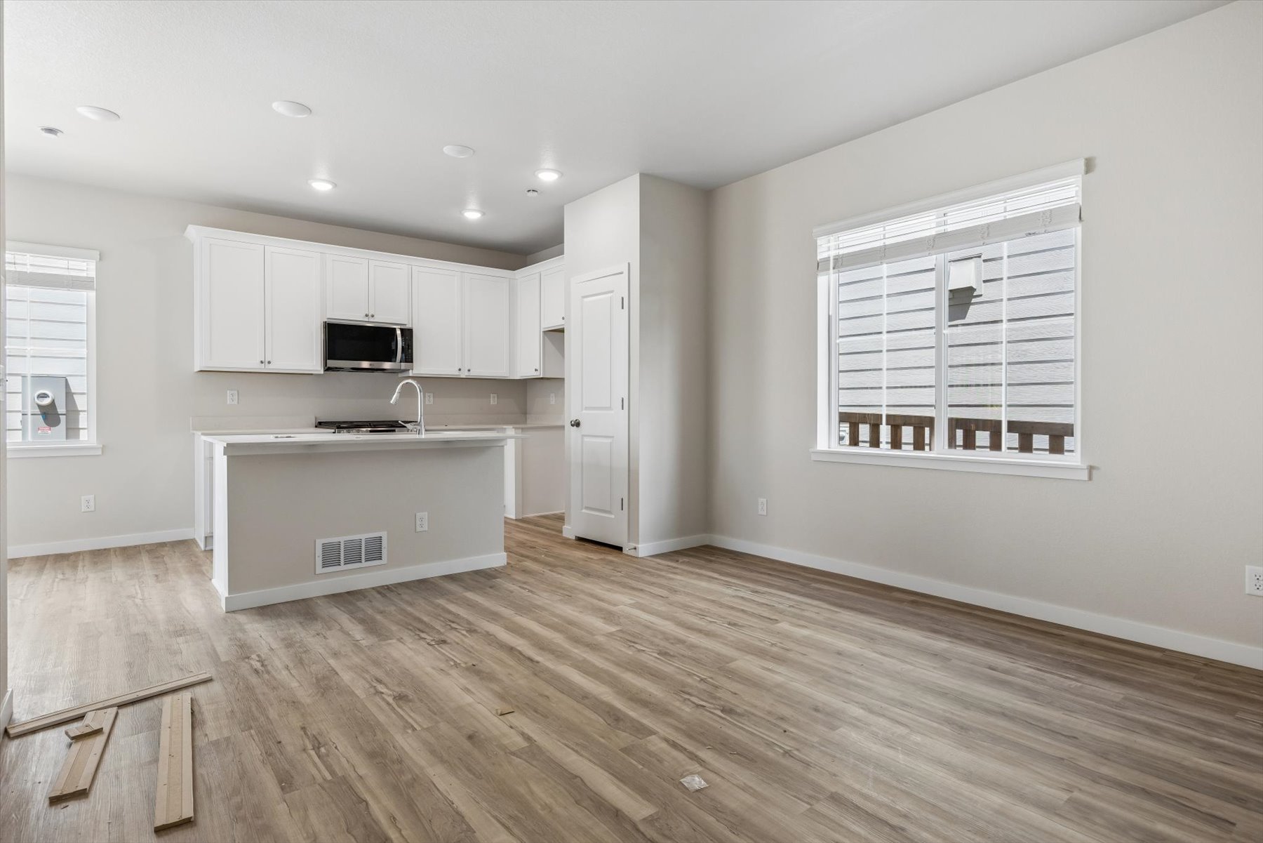 A kitchen with white cabinets.