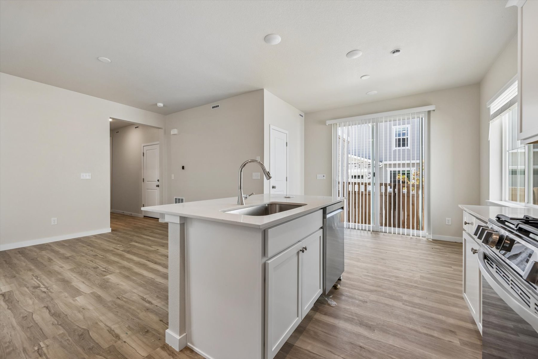 A kitchen with white cabinets.