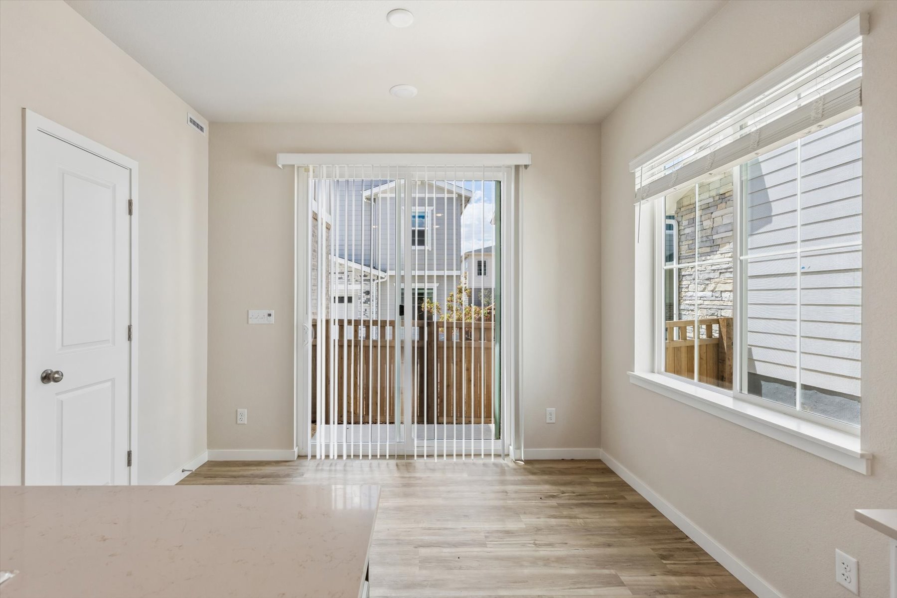 A room with a glass door and a wood floor.