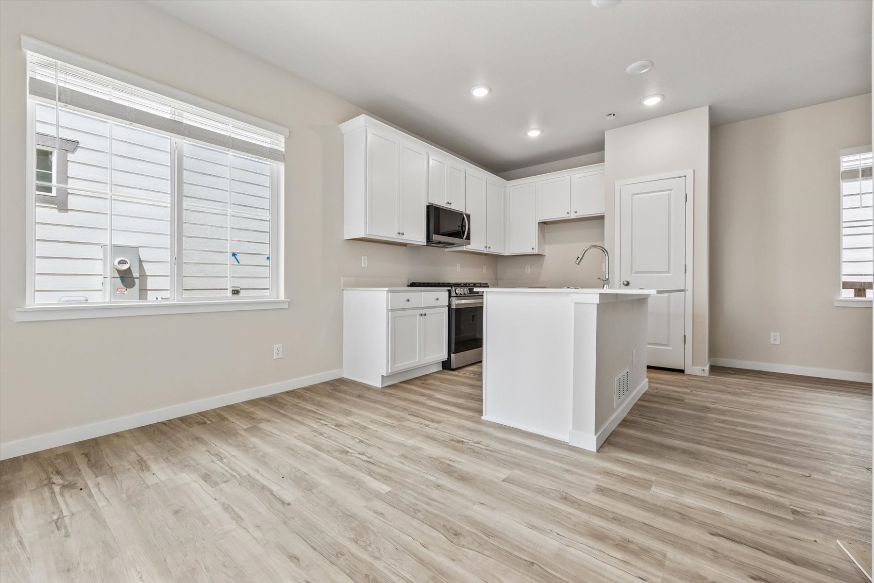A kitchen with white cabinets.