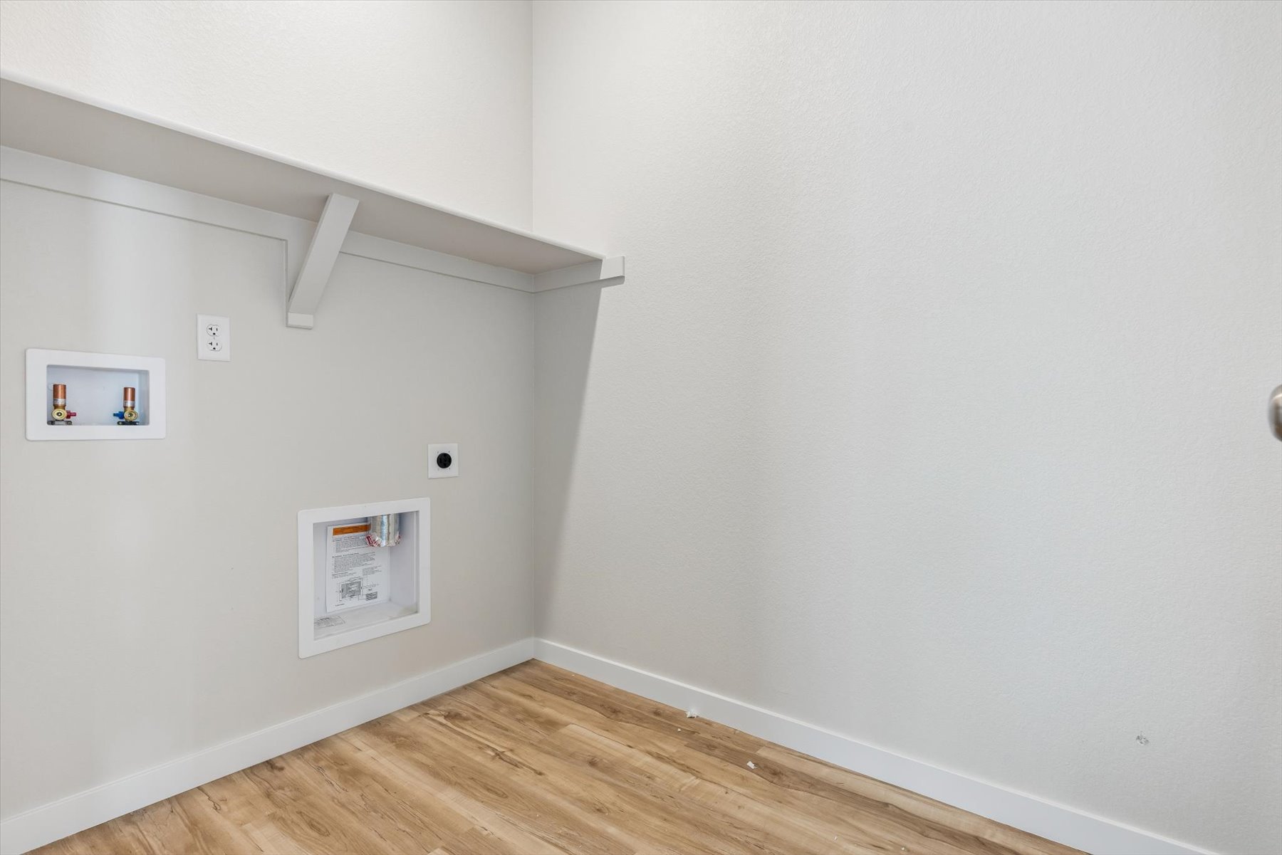 A white wall with pictures on it.
