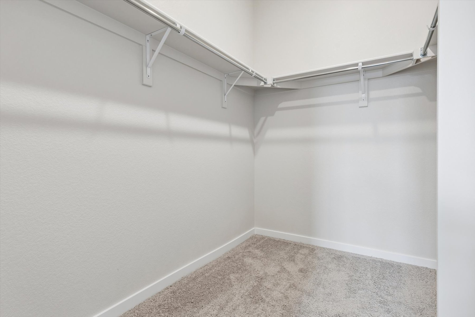 A white wall with a metal railing.