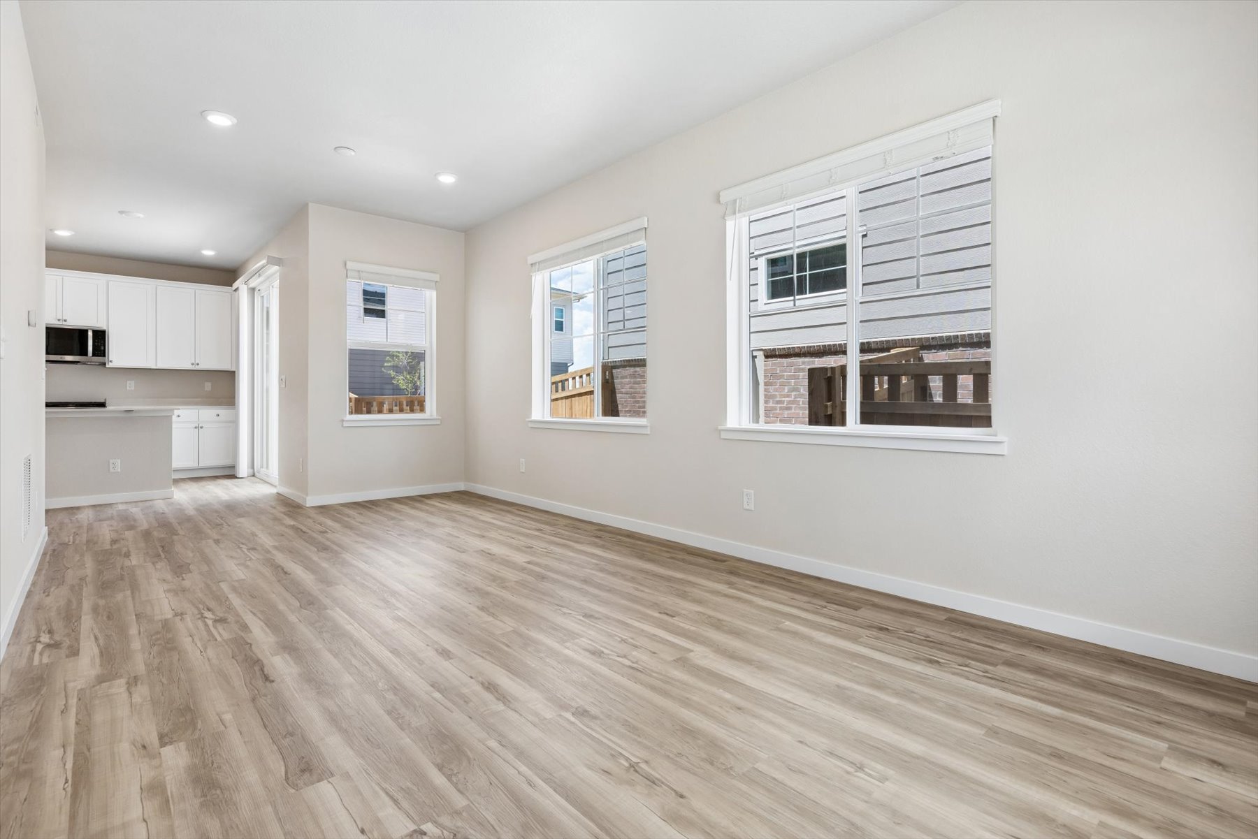 A room with a wood floor and white walls.