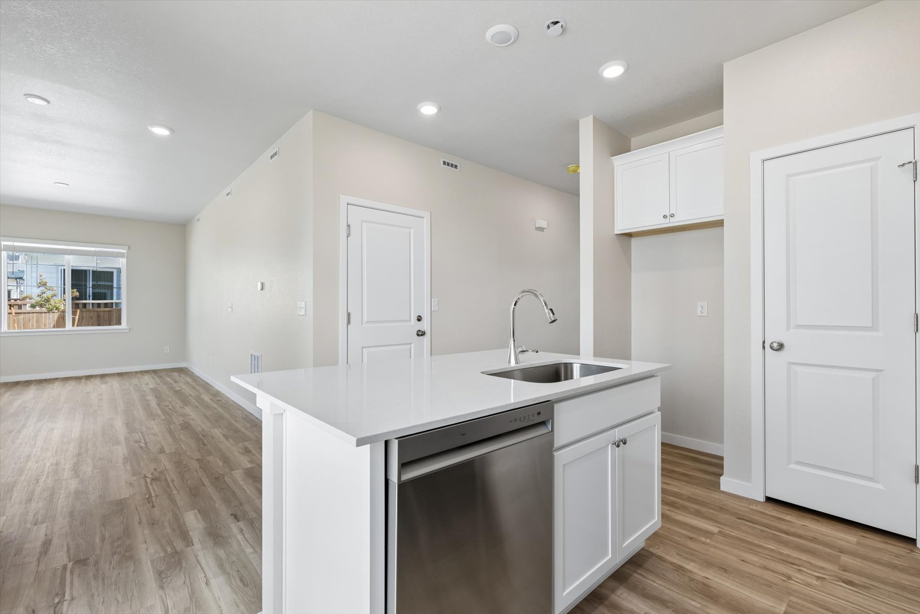 A kitchen with white cabinets.