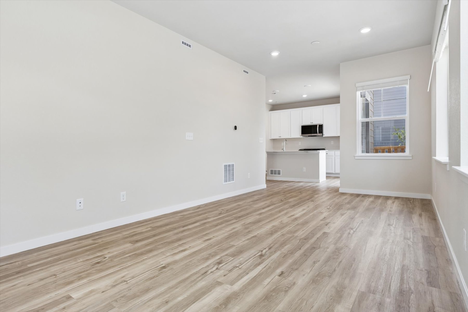A room with white walls and a wood floor.
