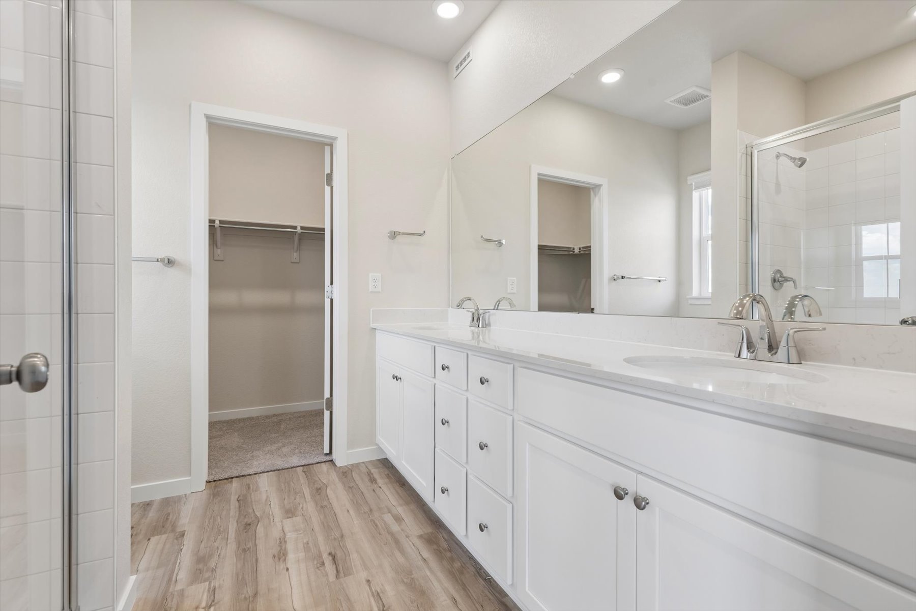 A bathroom with a tub sink and shower.