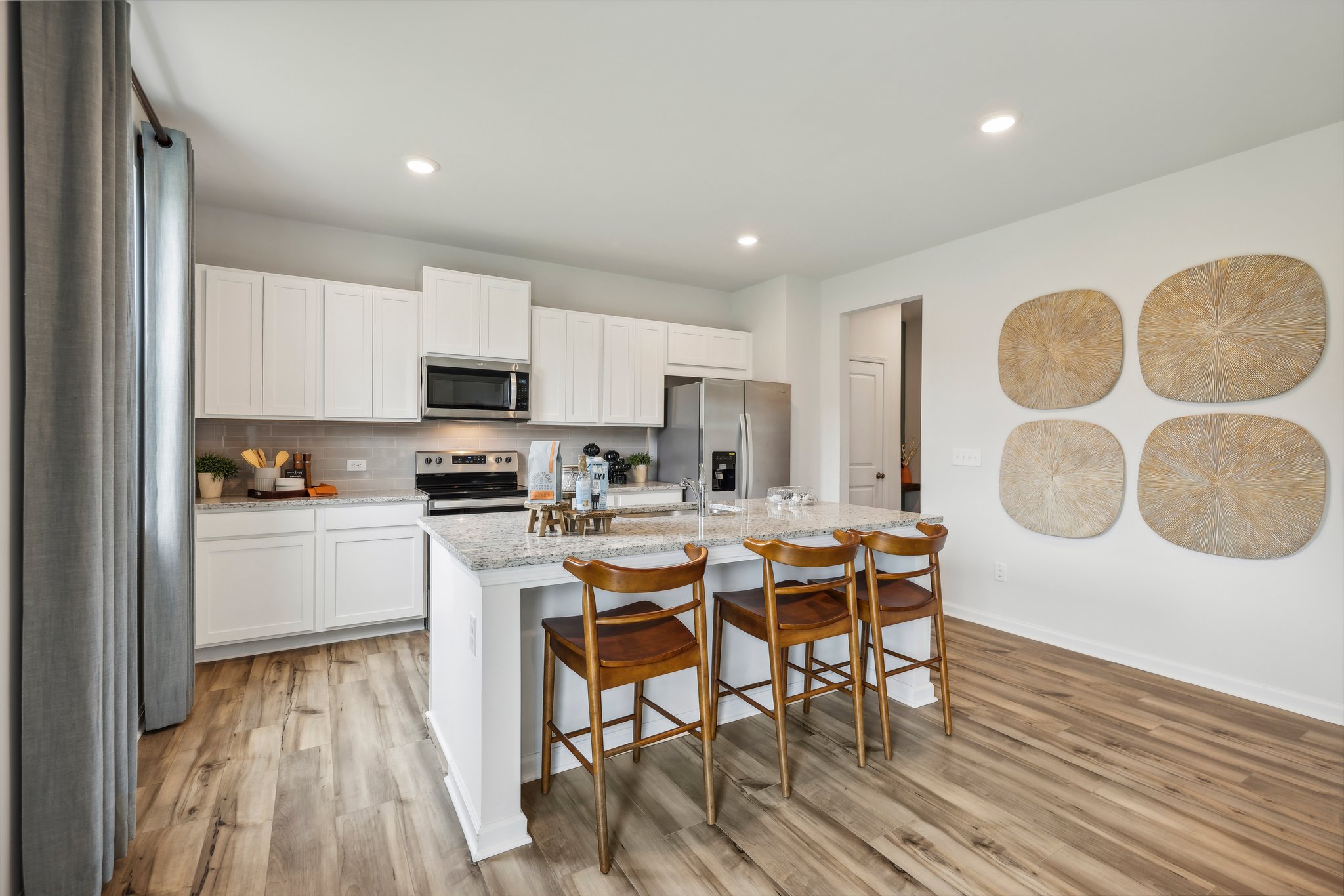 A kitchen with white cabinets.