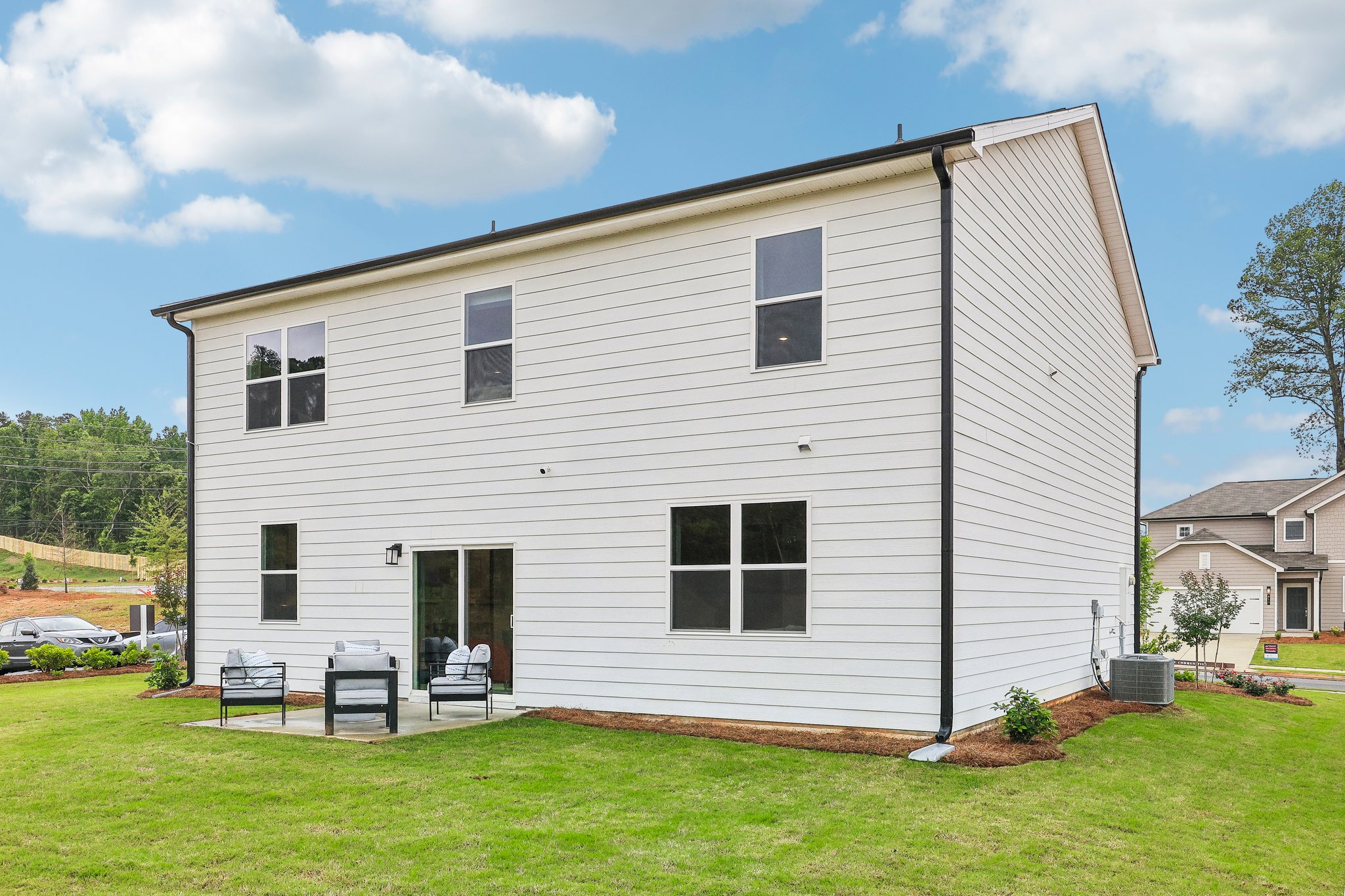 A white house with a lawn.