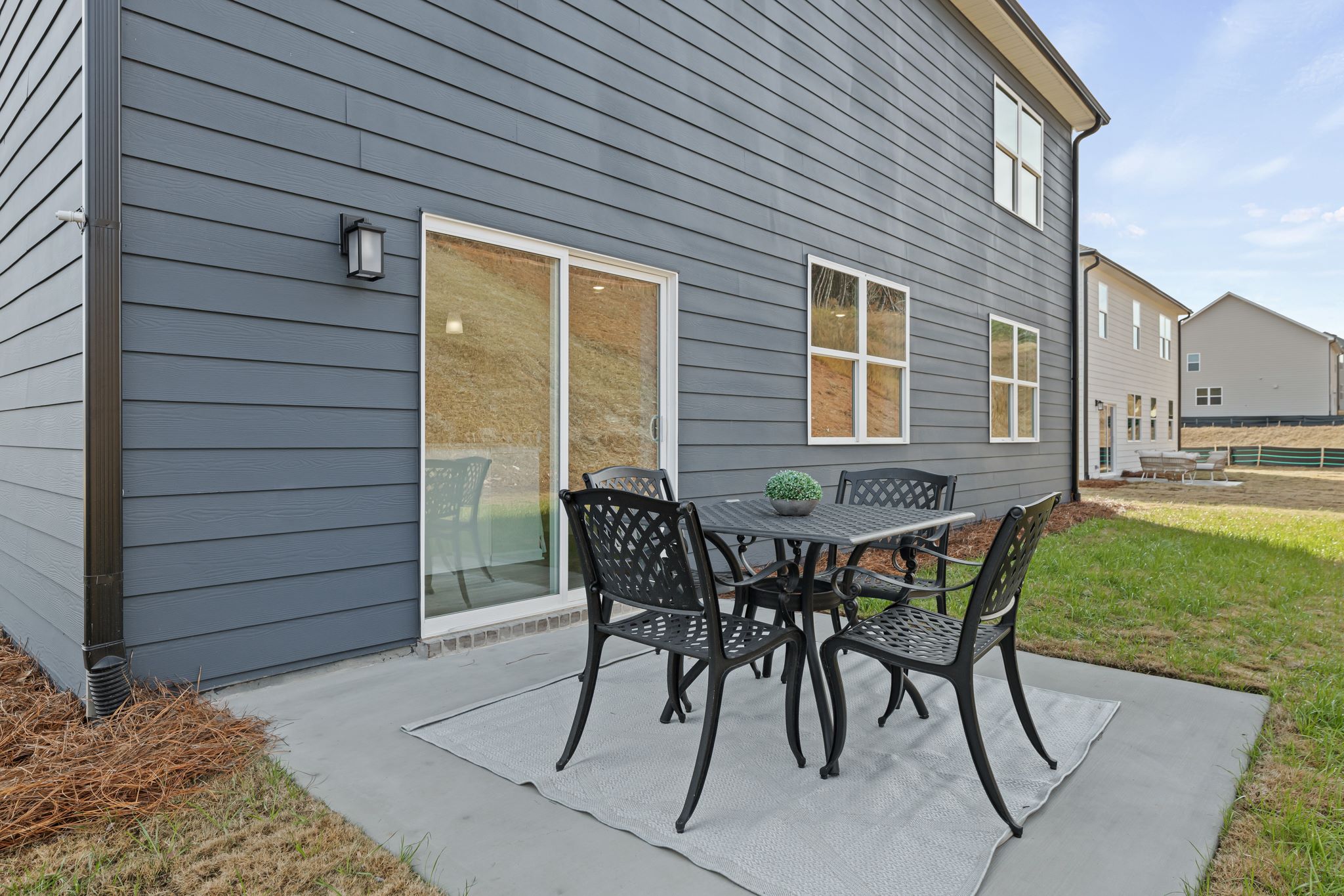 A table and chairs outside a house.