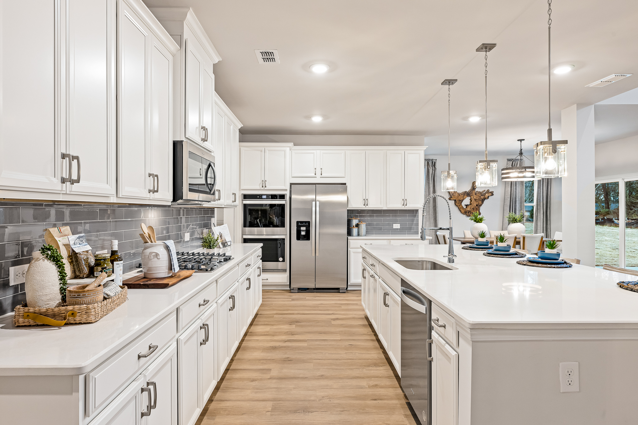 A kitchen with white cabinets.
