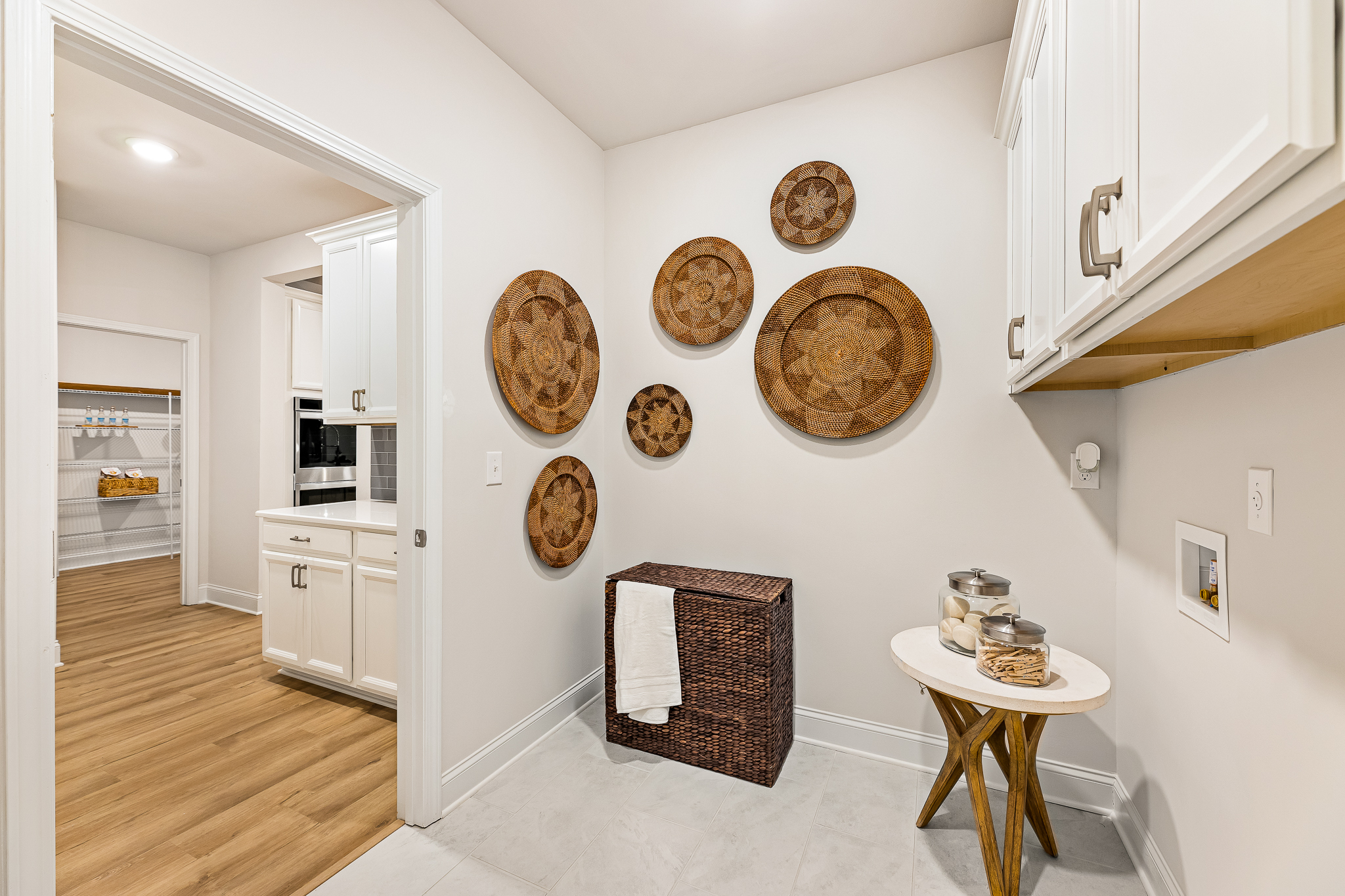 A kitchen with a table and chairs.
