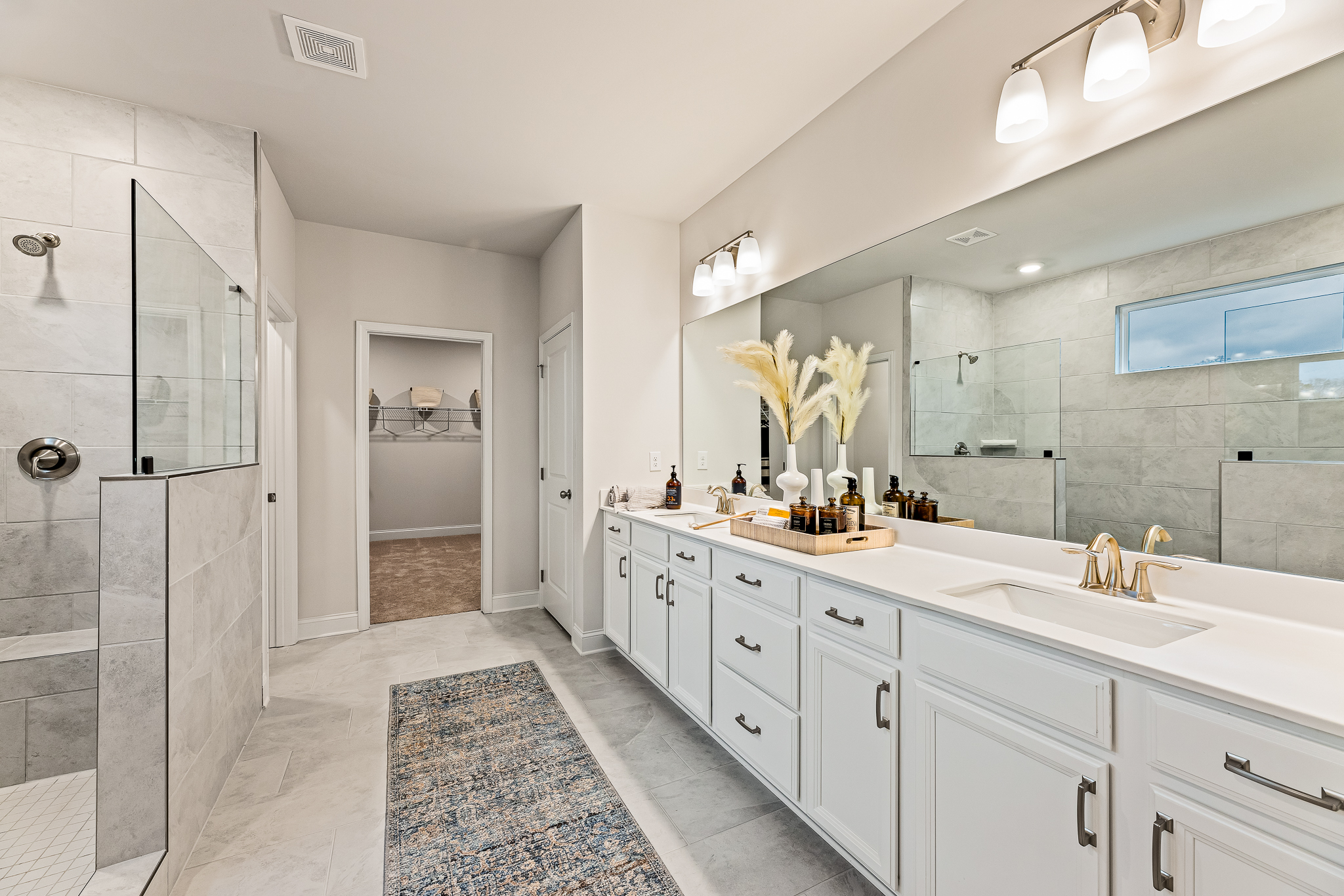 A bathroom with white cabinets.